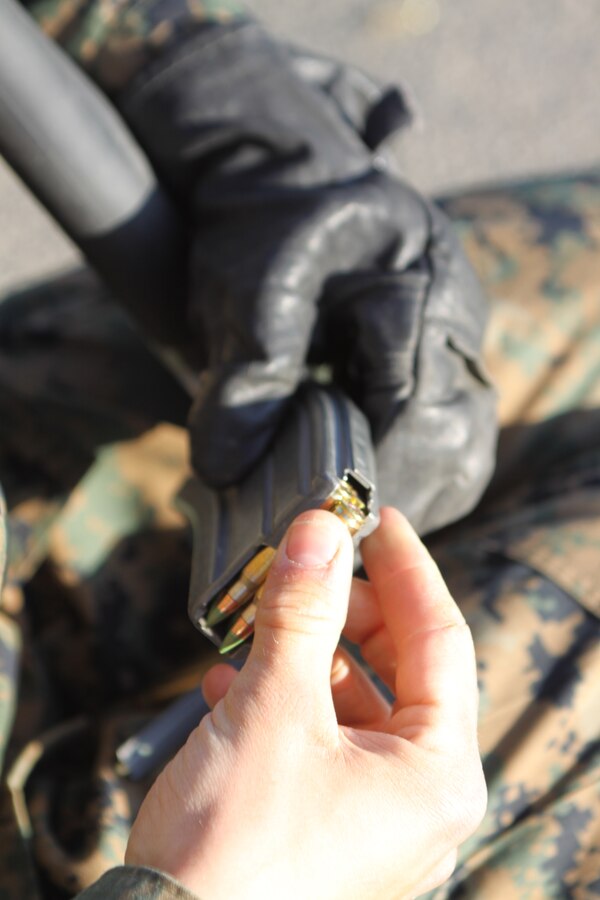 Recruits from Company L load ammunition while waiting their turn to fire their rifles down range on Delta Range, Edson Range, Weapons and Field Training Battalion, Marine Corps Base Camp Pendleton March 20. The recruits were guided on shooting techniques by primary marksmanship instructors that helped enfore the fundamentals of Marine Corps marksmanship. PMI's ensured Co. L recruits understood how to properly us the M-16 A4 service rifle.