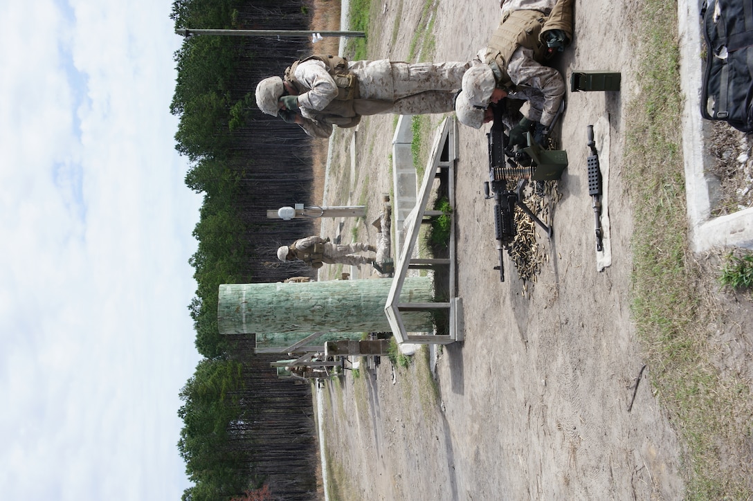 Marines and a corpsman with Battery T, 5th Battalion, 10th Marine Regiment, take their positions along the gun line. The unit spent the day refreshing their skills with the M240-B machine gun with senior corporals and sergeants coaching their junior Marines and sailors.