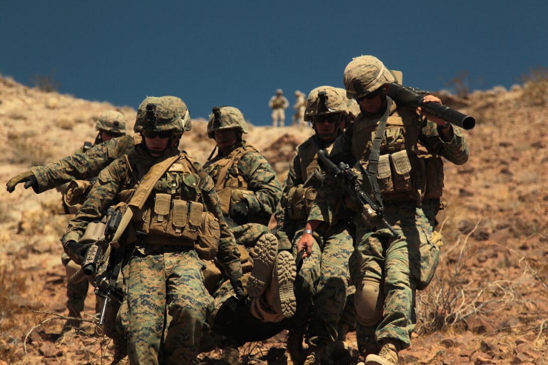 Marines with the Infantry Officers’ Course, carry a simulated casualty down a steep hill during a mountain attack in the Bullion training area March 21, 2012. The mountain attack was part of their four-day culminating exercise from PALM FEX.