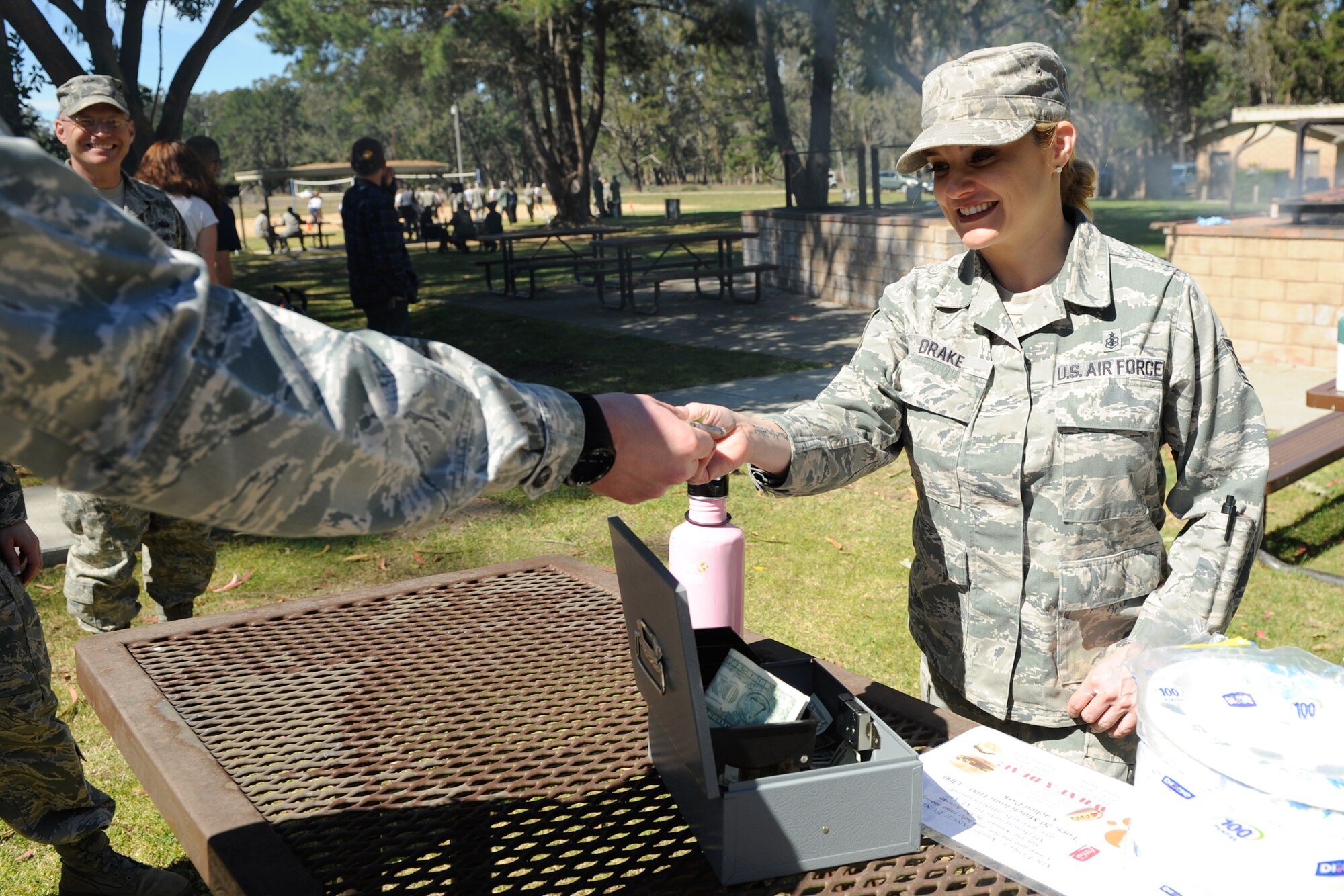 VANDENBERG AIR FORCE BASE, Calif. -- Tech. Sgt. Tracey Drake, the NCO in charge of Tricare operations at the 30th Medical Support Squadron, collects donations during the Air Force Assistance Fund kick-off barbeque at Cocheo Park here Tuesday, March 20, 2012. According to the AFAF website, the fund was established as an annual fundraiser for the charities that directly support Air Force people. (U.S. Air Force photo/Staff Sgt. Levi Riendeau)
