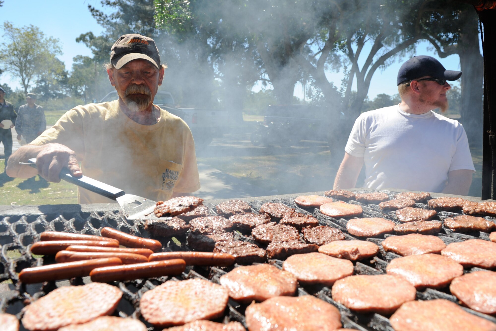 VANDENBERG AIR FORCE BASE, Calif. -- Pat O'Neil, a dirt boy with the 30th Civil Engineer Squadron horizontal shop, grills hamburgers and hotdogs for the Air Force Assistance Fund kick-off barbeque at Cocheo Park here Tuesday, March 20, 2012. According to the AFAF website, the fund was established as an annual fundraiser for the charities that directly support Air Force people. (U.S. Air Force photo/Staff Sgt. Levi Riendeau)
