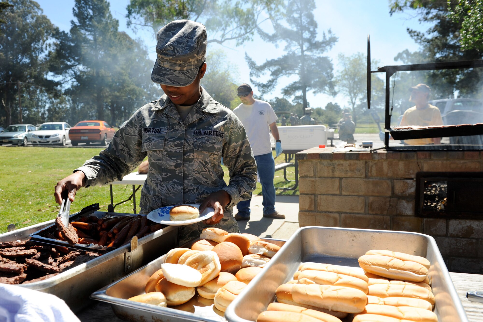VANDENBERG AIR FORCE BASE, Calif. -- Senior Airman Brianna Horton, a knowledge operator with th 30th Launch Group, grabs some lunch during the Air Force Assistance Fund kick-off barbeque at Cocheo Park here Tuesday, March 20, 2012. According to the AFAF website, the fund was established as an annual fundraiser for the charities that directly support Air Force people. (U.S. Air Force photo/Staff Sgt. Levi Riendeau)
