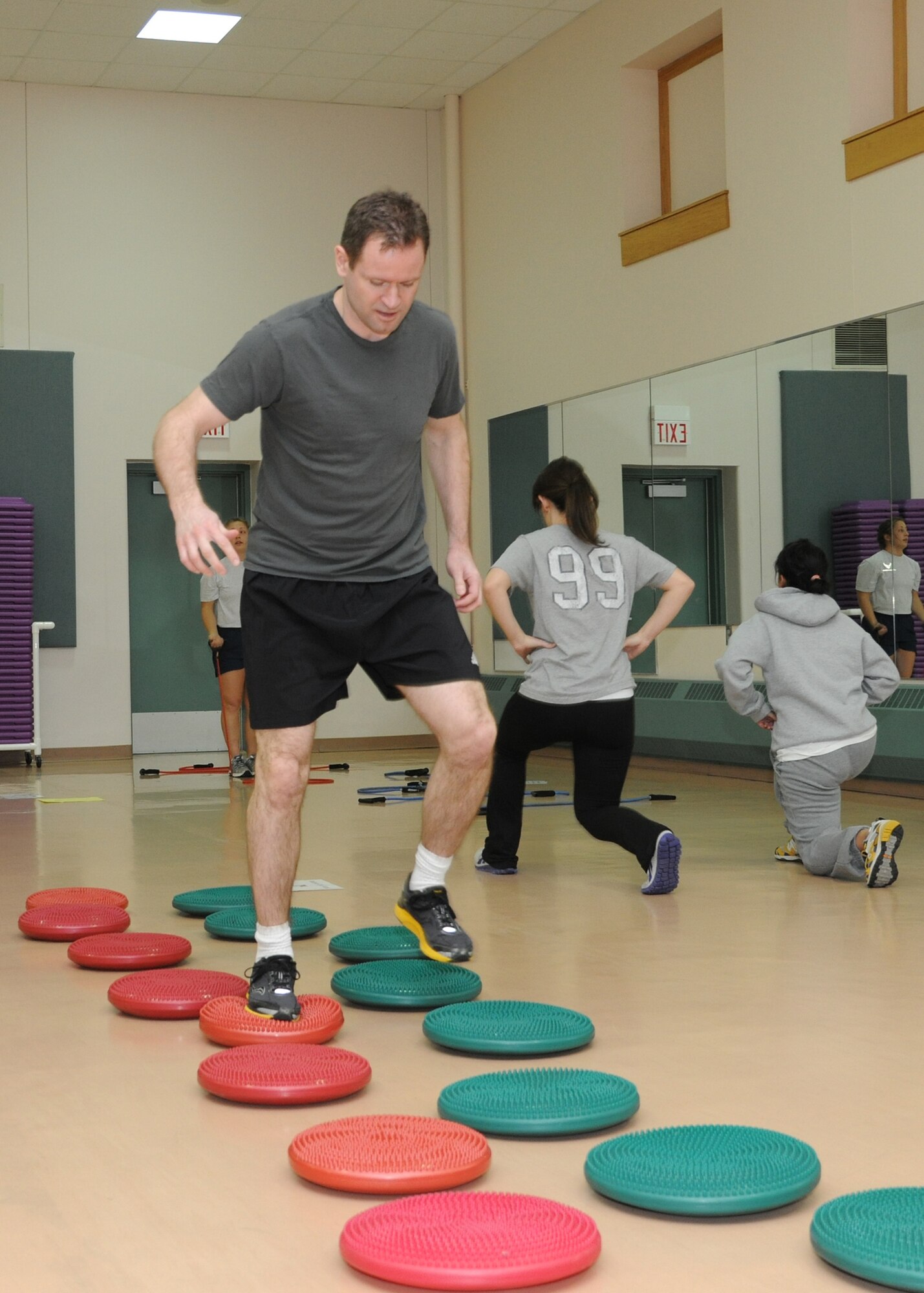 Lt. Col. Brandon Hart, 319th Air Base Wing, tests his footwork on balance discs at a Soar into Shape obstacle course March 8, 2012, on Grand Forks Air Force Base, N.D.  Soar into Shape is a nine-week challenge allowing participants to decide whether to lose or maintain weight, ultimately improving their overall physical health.  (U.S. Air Force photo/Airman 1st Class Ashley N. Taylor) 