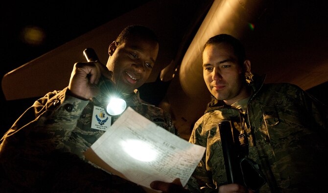 Tech. Sgt. Nasir Ahmad, left, and Staff Sgt. Ryan Boudreaux, 28th Maintenance Group quality assurance inspectors and members of the base Exercise Evaluation Team, perform an aircraft inspection following B-1 bomber maintenance during an Operational Readiness Exercise at Ellsworth Air Force Base, S.D., March 15, 2012. EET members inspected and evaluated Airmen on their ability to perform their duties quickly and efficiently without errors. (U.S. Air Force photo by Airman 1st Class Kate Thornton/Released)