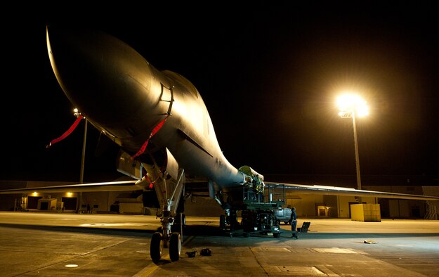 Amid the glow of lights on the flightline in the early morning, 28th Aircraft Maintenance Squadron crew chiefs repair a B-1 bomber radome during an Operational Readiness Exercise at Ellsworth Air Force Base, S.D., March 15, 2012. The exercise tested the base’s ability to rapidly mobilize and process assets during a simulated contingency tasking. (U.S. Air Force photo by Airman 1st Class Kate Thornton/Released)