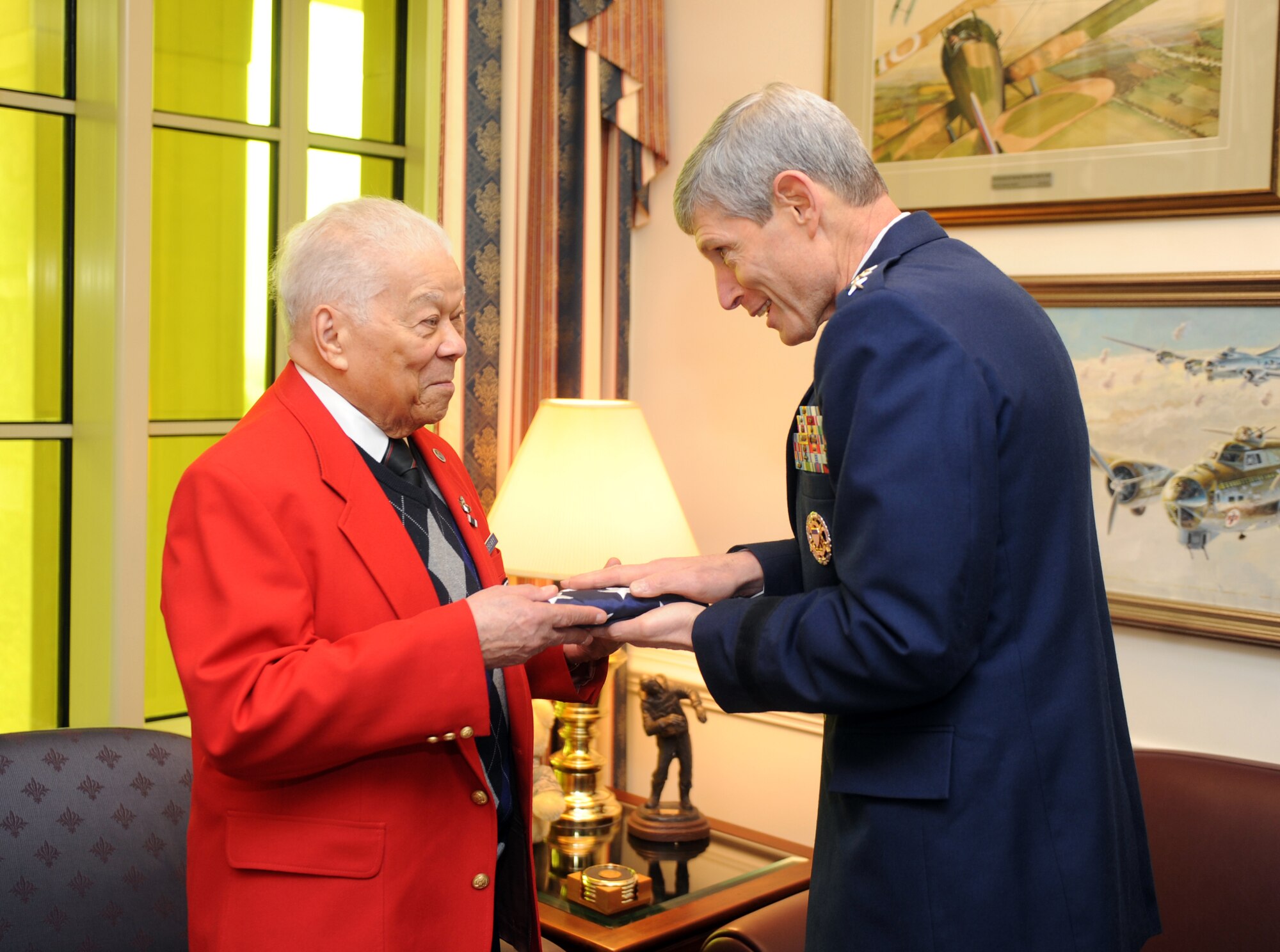 Air Force Chief of Staff Gen. Norton Schwartz presents an American flag that was flown over the Pentagon to retired Lt. Col. Walter McCreary on March 16, 2012. Schwartz hosted McCreary, an original Tuskegee Airman, for an office call.  (U.S. Air Force photo/ Andy Morataya)