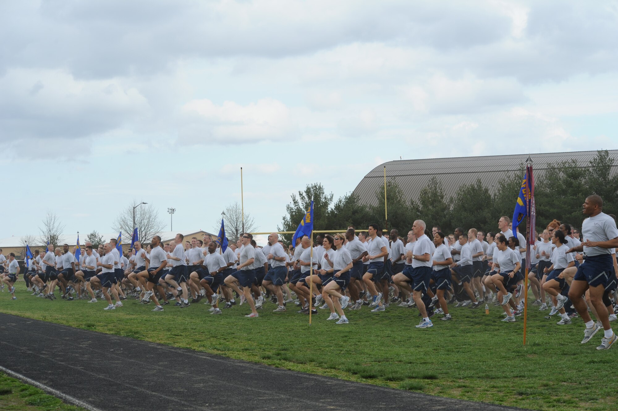 Members of the 844th Communications Group cross the finish line after a fun run kick-off event for the Air Force Assistance Fund at Joint Base Andrews, Md., on March 19. Various Units from Air Force District of Washington, 11th Wing, 79th Medical Wing and Joint Base Anacostia-Bolling, D.C., participated in the 2-mile run. (U.S. Air Force photo/ Staff Sergeant Matt Coleman-Foster)