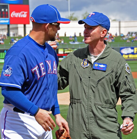 Texas Rangers' Brandon Snyder represented his team March 19, when he caught for 10th Air Force Commander Brig. Gen. William B. Binger's first pitch at the Spring Training game at Surprise Stadium in Ariz. (U.S. Air Force Photo/Staff Sgt. Denise Willhite) 

