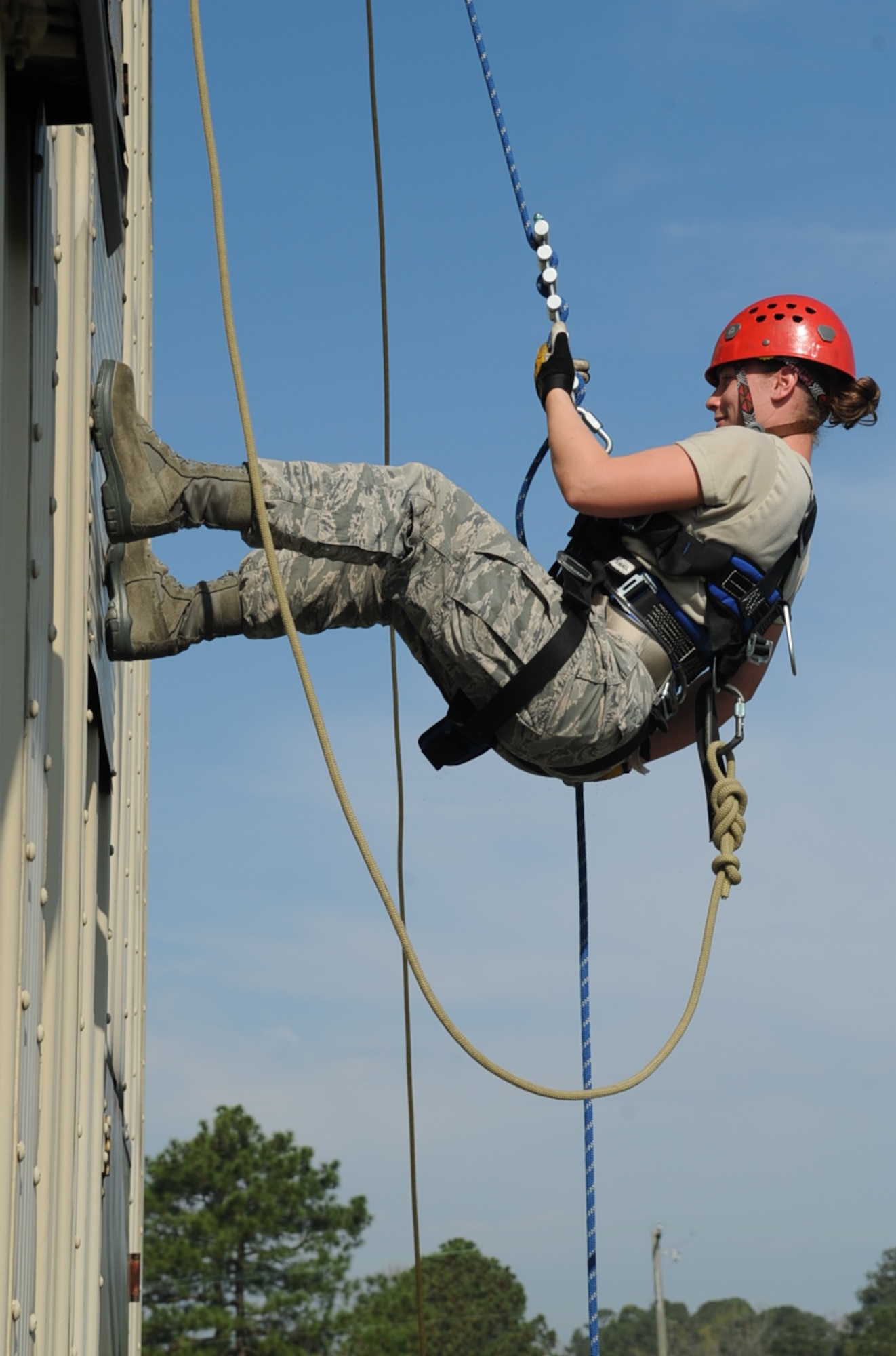 U.S. Air Force Senior Airman Samantha Tremblay rappels off the burn tower on Seymour Johnson Air Force Base, N.C., as a part of a Department of Defense Rescue Technician Course on March 20, 2012. The course teaches Airmen various rescue techniques used during real-world emergency responses. Tremblay, 28th Civil Engineer Squadron Civil Engineer flight at Ellsworth Air Force Base, S.D., hails from Fort Lauderdale, Fla. (U.S. Air Force photo/Airman First Class Aubrey Robinson/Released)
