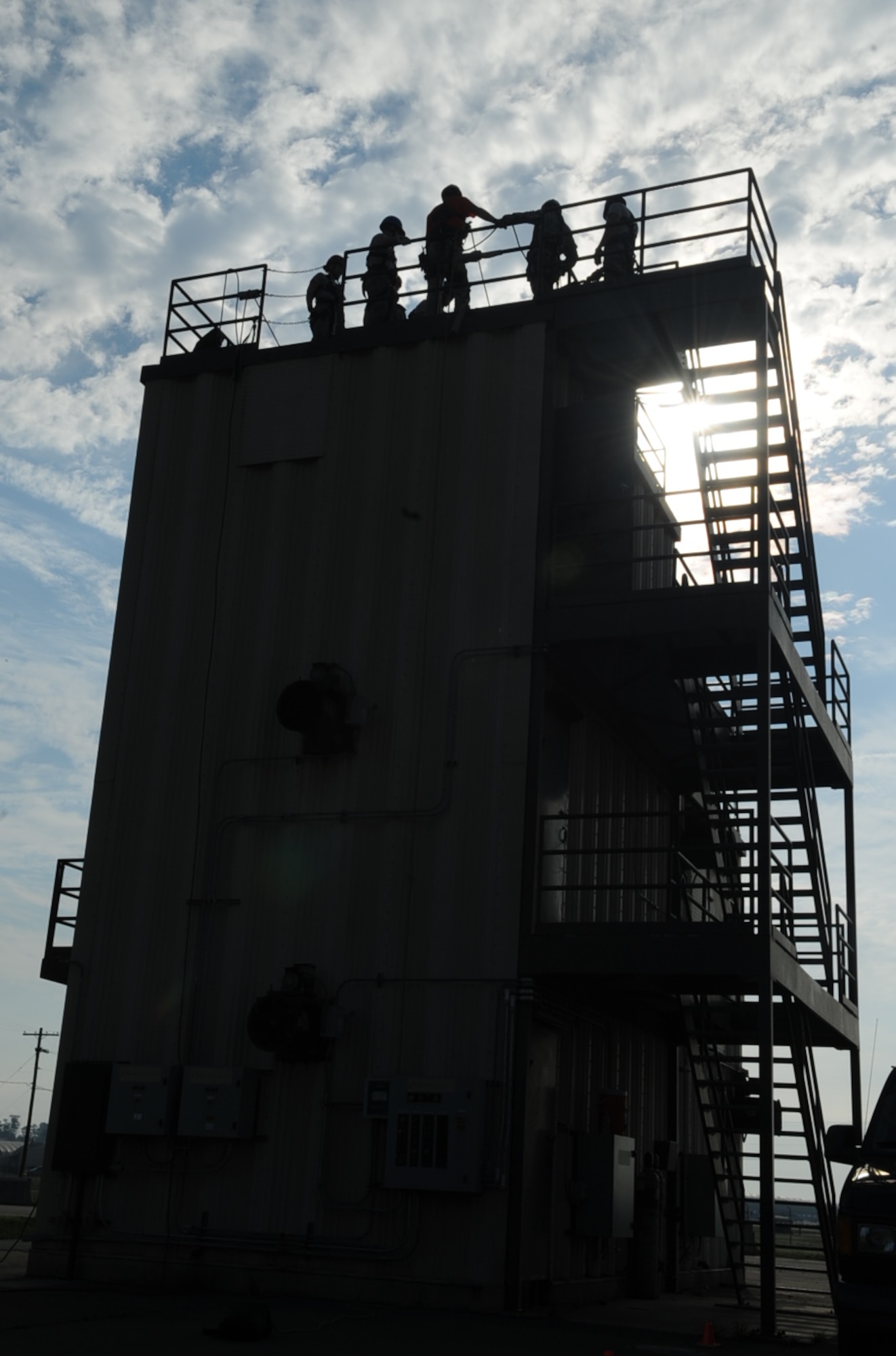 Airmen prepare to rappel off the burn tower during the Department of Defense Rescue Technician Course on Seymour Johnson Air Force Base, N.C., March 20, 2012. Airmen from various installations traveled here to attend the 15-day course learning various rescue techniques and how to apply them during real world emergency responses. (U.S. Air Force photo/Airman 1st Class Aubrey Robinson/Released)