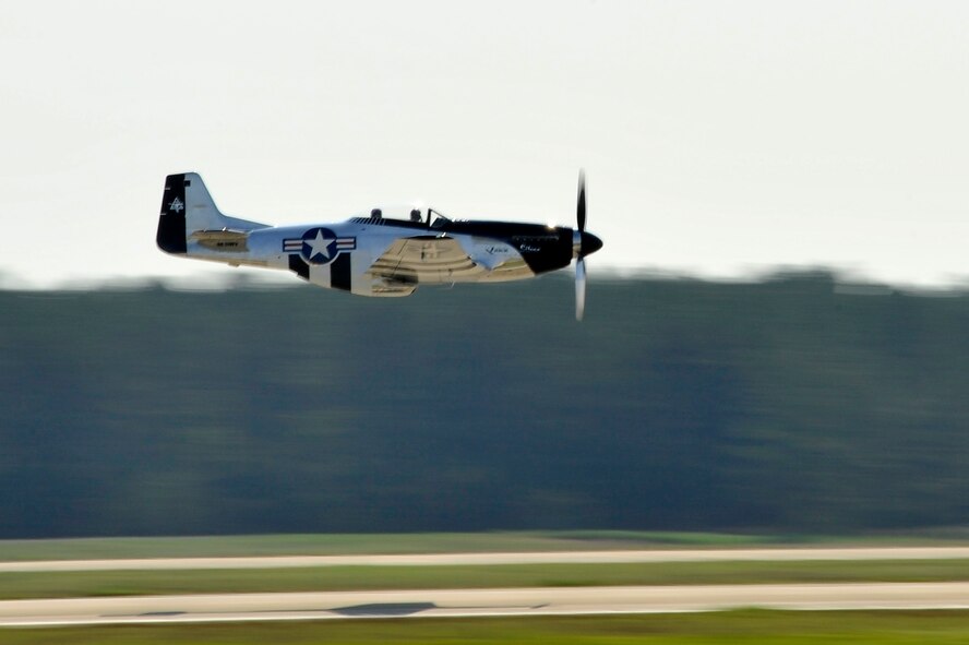 A P-51 Mustang passes over the Shaw flightline after being displayed as a static aircraft during the 20th Fighter Wing change of command ceremony, Shaw Air Force Base, S.C., March 19, 2012. The P-51 Mustang "Quick Silver" was restored more than 13 years ago by father and son Bill and Scott Yoak. Yoak's P-51 Mustang will be one of the many aircraft that will perform during the upcoming Shaw Air Expo, May 5-6. (U.S. Air Force photo by Senior Airman Kenny Holston/Released)

