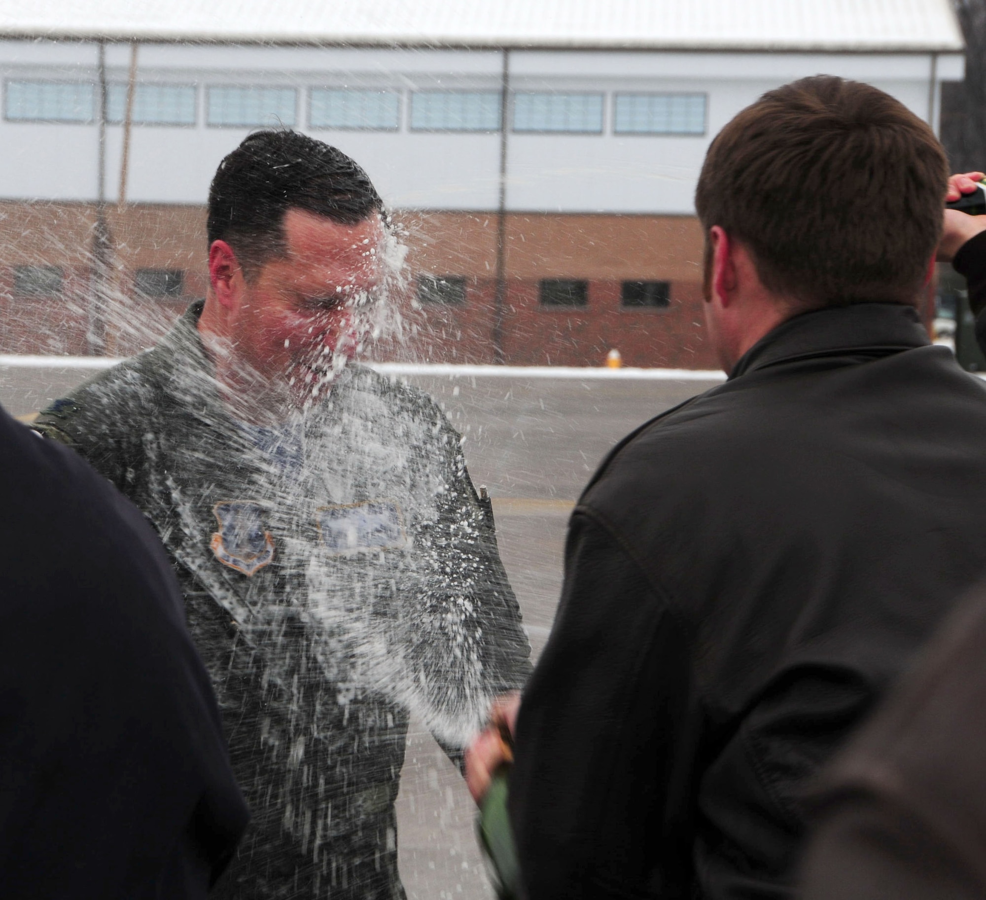 Col. Pete “Meat” Siana is greeted by the customary champagne dowsing following his “fini-flight” at Bradley Air National Guard Base in East Granby, Conn., March 3, 2012. Siana has flown for more than 23 years with the United States Air Force and has logged more than 4,000 military flying hours. (U.S. Air Force photo by Airman 1st Class Emmanuel Santiago)