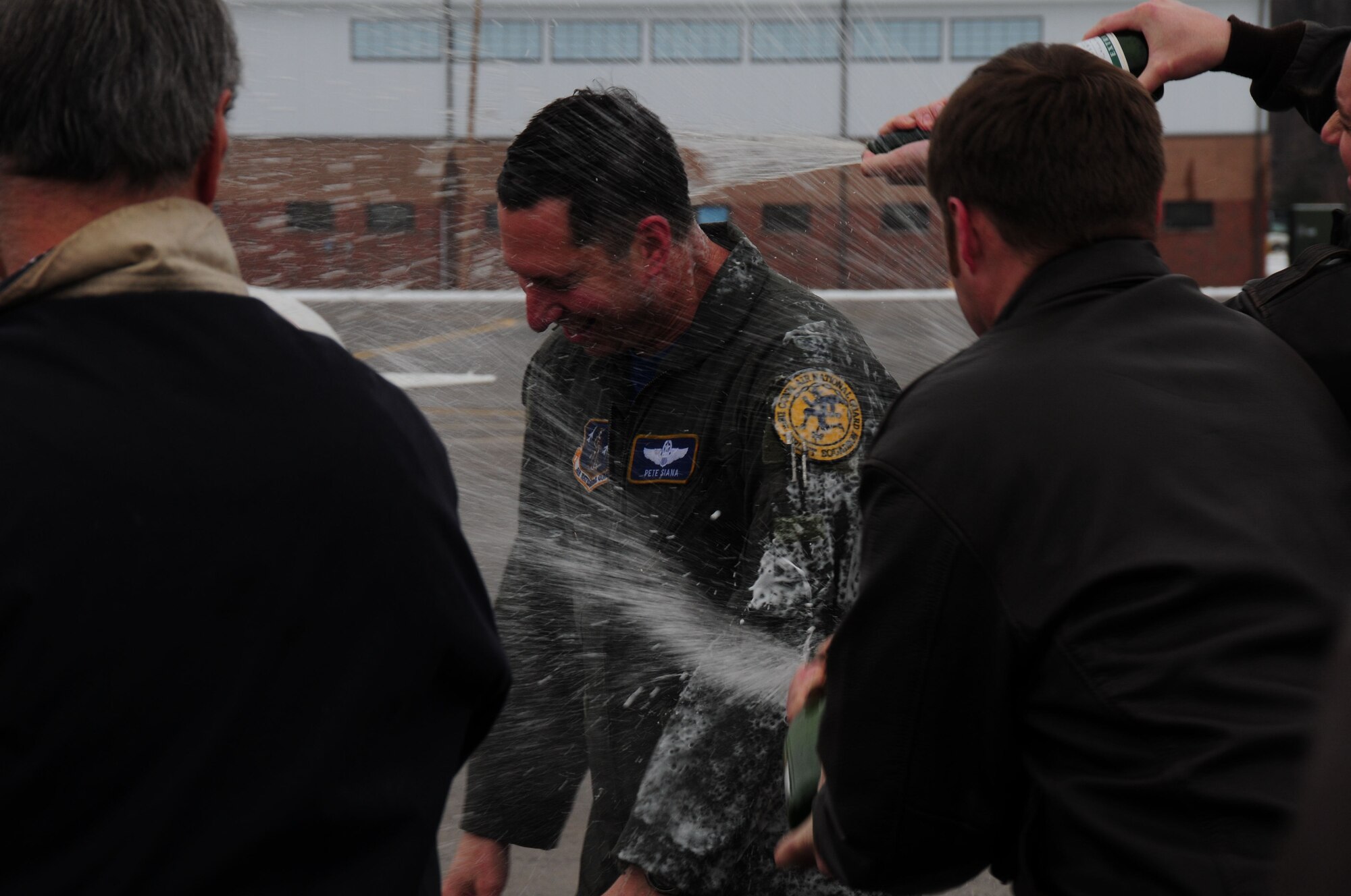 Col. Pete “Meat” Siana is greeted by the customary champagne dowsing following his “fini-flight” at Bradley Air National Guard Base in East Granby, Conn., March 3, 2012. Siana has flown for more than 23 years with the United States Air Force and has logged more than 4,000 military flying hours. (U.S. Air Force photo by Airman 1st Class Emmanuel Santiago)