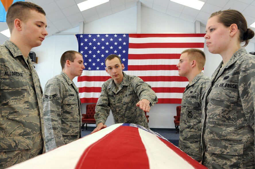 Senior Airman Benjamin Collins, center, trains new members of the Grand Forks Air Force Base Honor Guard where to properly position themselves as ceremonial guardsmen while performing military honors at a funeral service for an Air Force retired member March 8, 2012, at the Honor Guard training facility on Grand Forks AFB, N.D. Collins has participated in more than 150 ceremonies. Approximately 100 of those ceremonies involved rendering military honors at funerals. (U.S. Air Force photo/Airman 1st Class Xavier Navarro)
