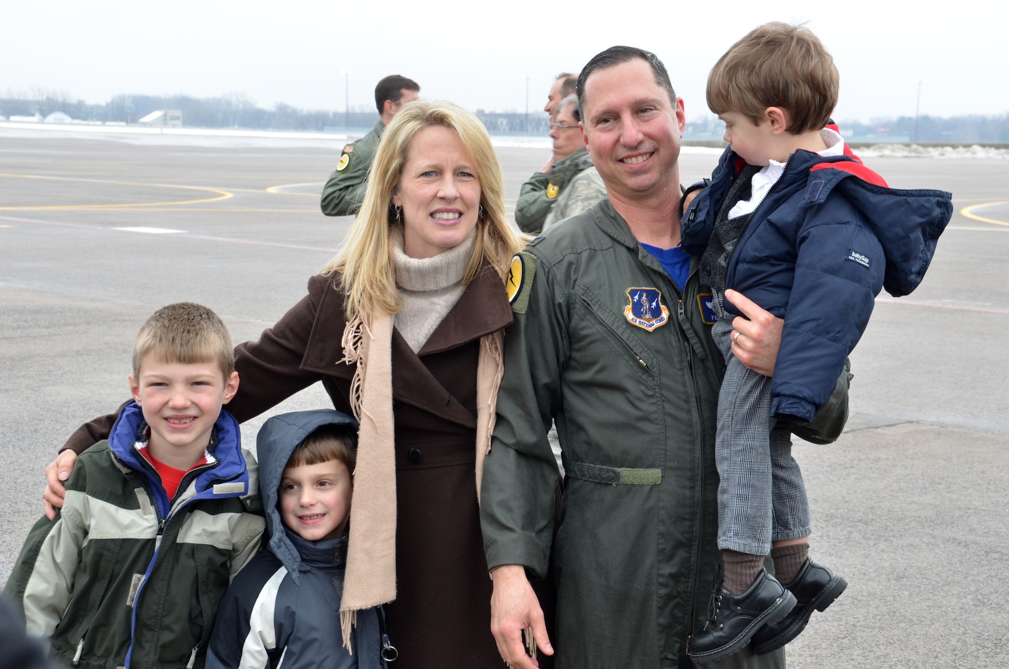 Col. Pete “Meat” Siana is surrounded by his family after completing his “fini-flight” March 3, 2012, at Bradley Air National Guard Base, East Granby, Conn. With Siana are his wife Dawn and three boys Peter, 7, Joseph, 6 and Jack, who is 2. (U.S. Air Force photo by Tech. Sgt. Joshua Mead)