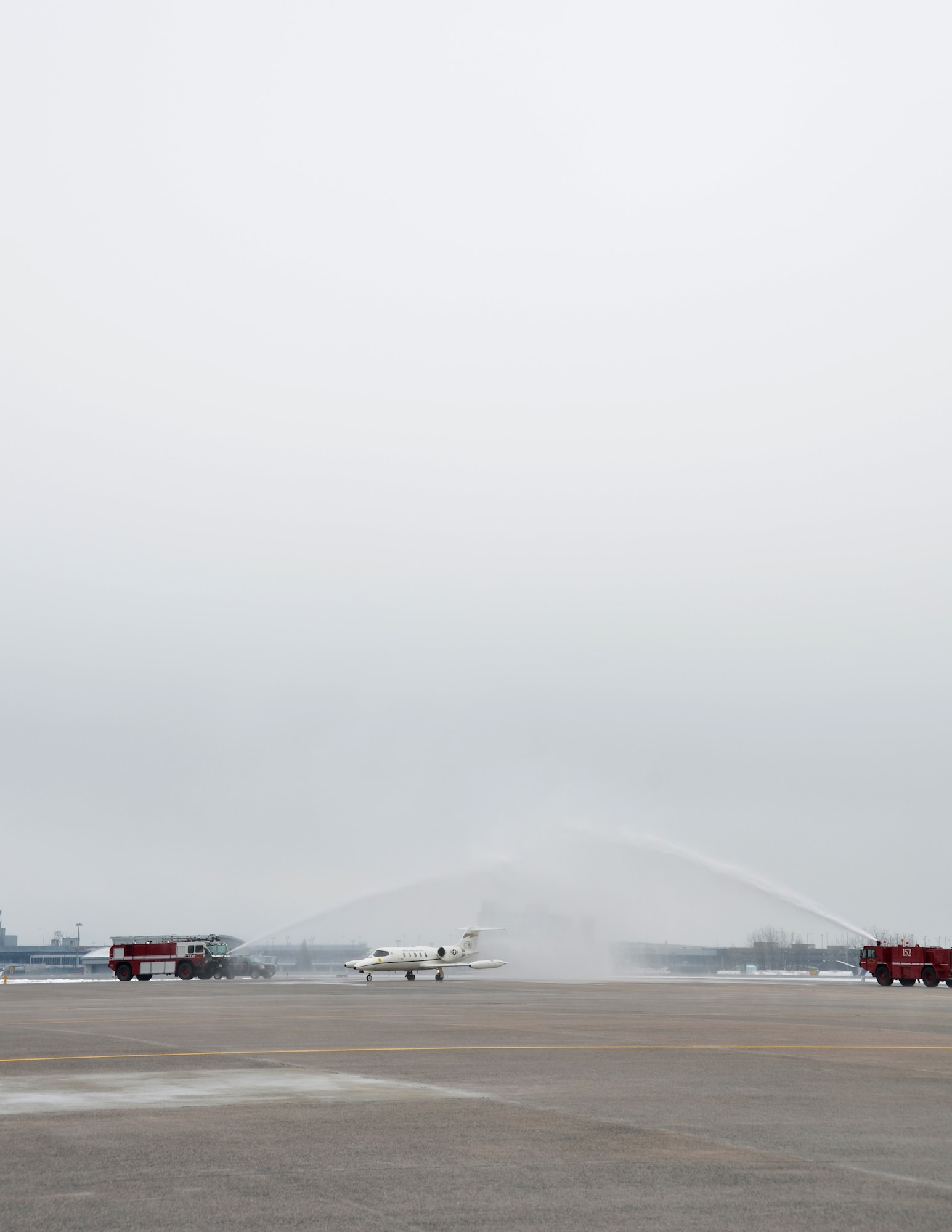 Col. Pete “Meat” Siana, is greeted by the 103rd Fire Department spraying down his C-21 as he taxis onto the flightline after his “fini-flight” at Bradley Air National Guard Base in East Granby, Conn., March 3, 2012. Siana has flown for more than 23 years with the United States Air Force and has logged more than 4,000 military flying hours. (U.S. Air Force photo by Tech. Sgt. Joshua Mead)