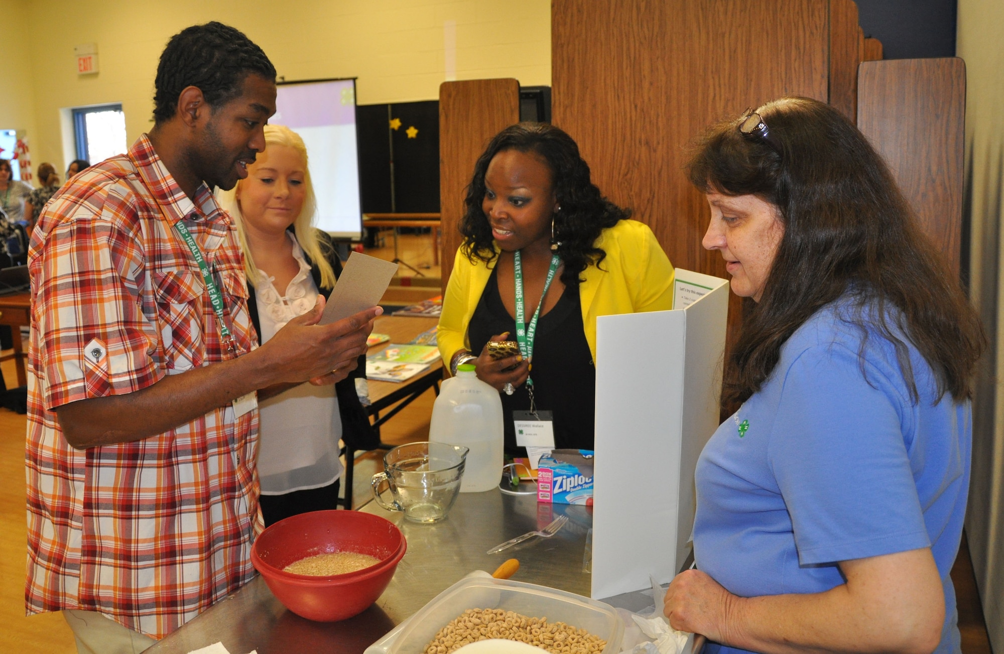 Youth development professionals Lamar Moorehead, Joint Base Charleston, S.C.; Emma Kinney, Scott Air Force Base, Ill., and Dessiree Wallace, Joint Base McGuire-Dix-Lakehurst, N.J., check the iron levels in cereal during the skill-a-thon – part of the 4-H “101” training held March 13-16, 2012, at Scott AFB, Ill. The 4-H 101 training program highlights the delivery and support of 4-H youth development and the ability for Air Force Youth Programs to engage with each state's land-grant university in offering high quality programming. (U.S. Air Force photo/James L. Hodges)