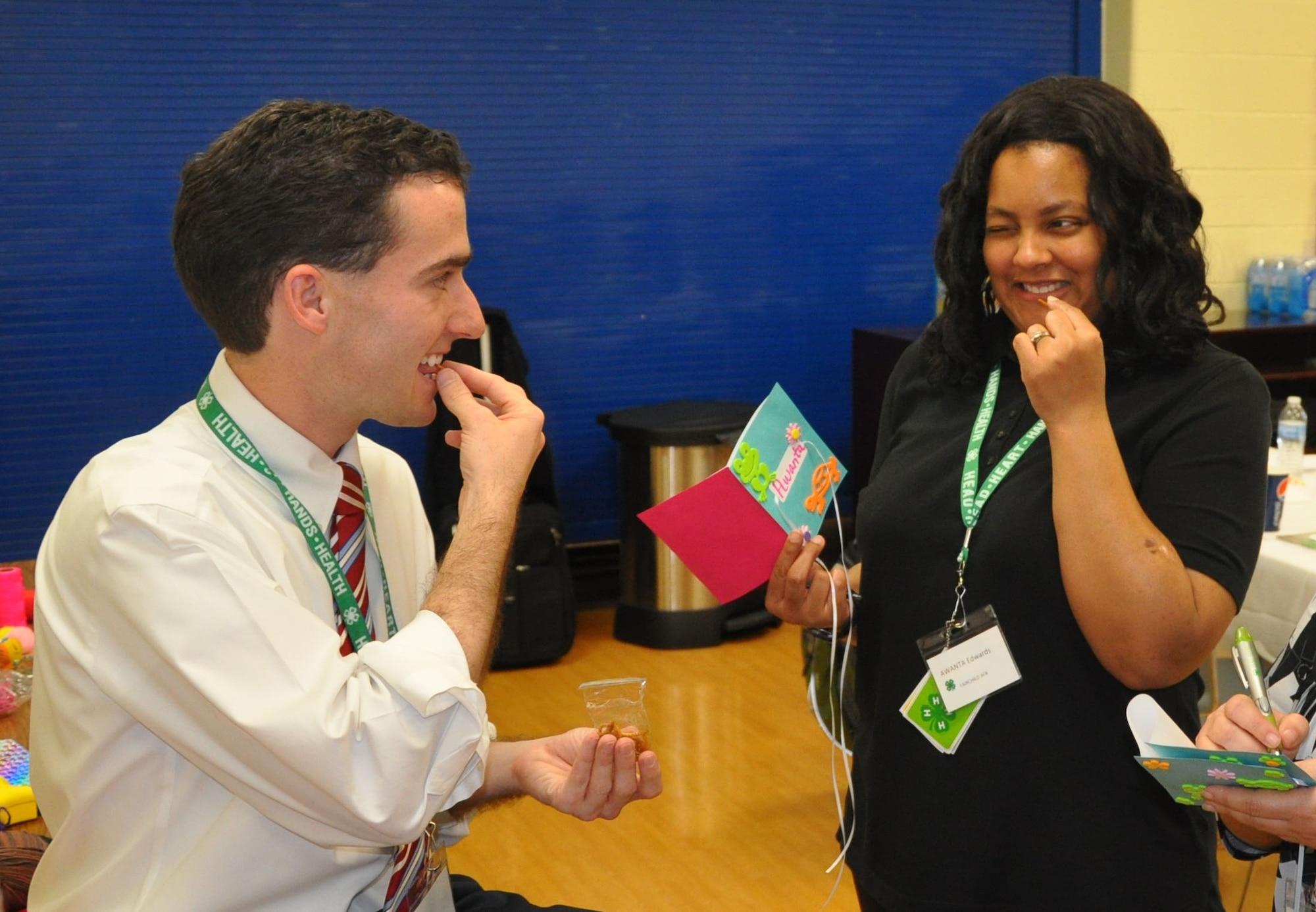 Casey Mull, state military coordinator at the University of Georgia, and youth development professional Awanta Edwards, Fairchild Air Force Base, Wash., try meal worms after learning about insects during the skill-a-thon – , part of the 4-H “101” training held March 13-16, 2012, at Scott AFB. The 4-H 101 training program highlights the delivery and support of 4-H youth development and the ability for Air Force Youth Programs to engage with each state's land-grant university in offering high quality programming. (U.S. Air Force photo/James L. Hodges)