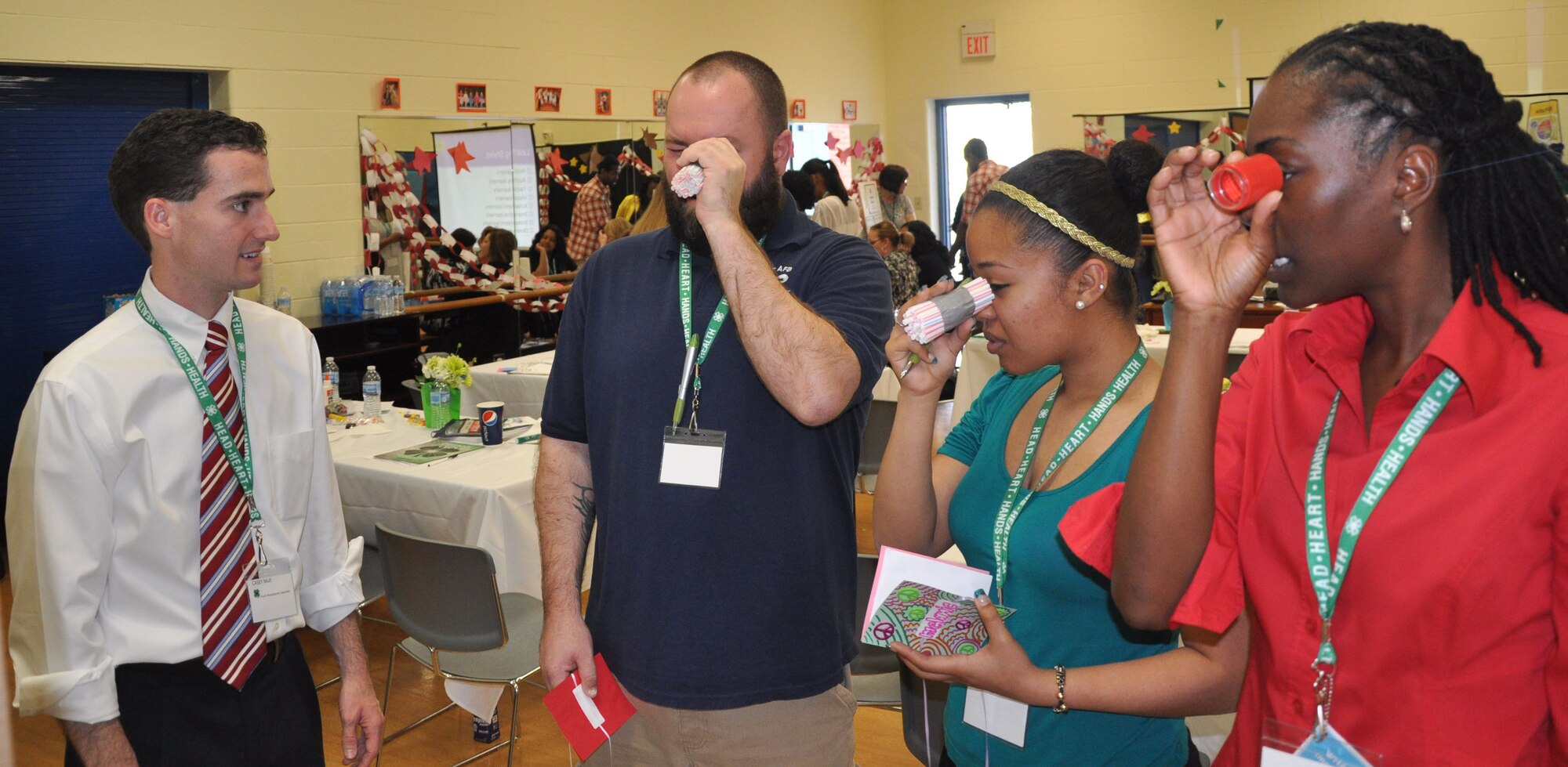 Casey Mull state military coordinator at the University of Georgia, left, teaches youth development professionals David Jaworski, Scott Air Force Base, Ill.; Melanie Stalworth, Dover AFB, Del.; and Meccanena Bilaal, Joint Base McGuire-Dix-Lakehurst, N.J., how a bug sees during the skill-a-thon, part of the 4-H “101” training held March 13-16, 2012, at Scott AFB, Ill. The 4-H 101 training program highlights the delivery and support of 4-H youth development and the ability for Air Force Youth Programs to engage with each state's land-grant university in offering high quality programming. (U.S. Air Force photo/James L. Hodges)