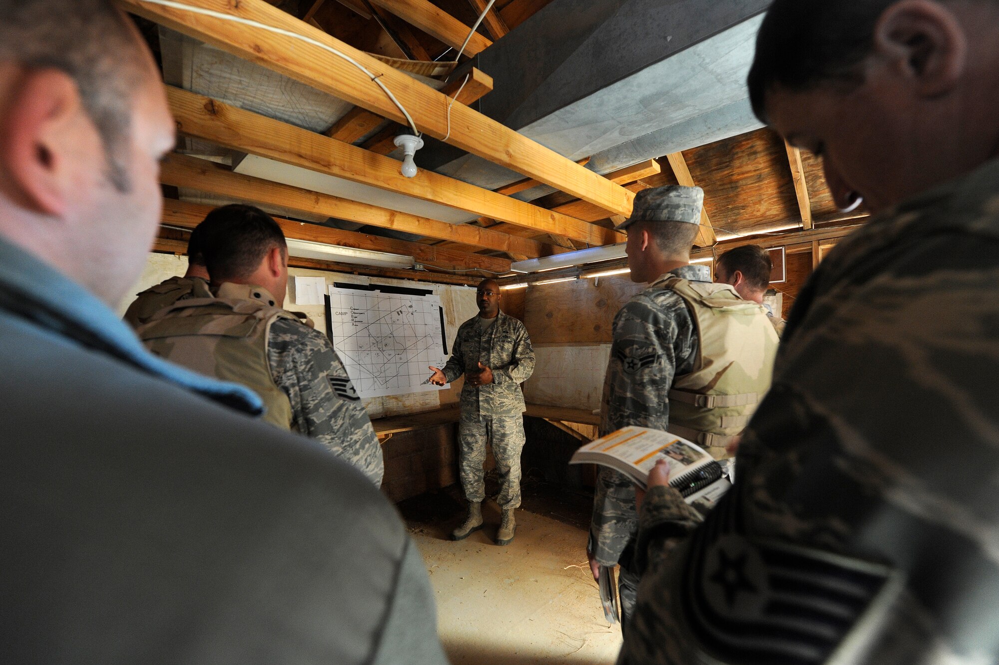 U.S. Air Force Senior Master Sgt. Lee Smith, 99th Civil Engineer Squadron emergency manager, teaches base defense tactics to Airmen during an Operational Readiness Exercise located at Camp C.O.B.R.A. March 21, 2012, at Nellis Air Force Base, Nev. The training helped enable Airmen from any career field to help defend a base in the event of a wartime attack. (U.S. Air Force photo by Staff Sgt. Christopher Hubenthal) 