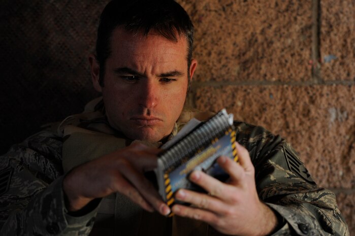 U.S. Air Force Staff Sgt. Robert McCall, 99th Civil Engineer Squadron firefighter, reviews his Airman's Manual during an Operational Readiness Exercise conducted at Camp C.O.B.R.A. March 21, 2012, at Nellis Air Force Base, Nev. The portion of the exercise tested Airmen on skills needed to survive in a wartime environment. (U.S. Air Force photo by Staff Sgt. Christopher Hubenthal) 
