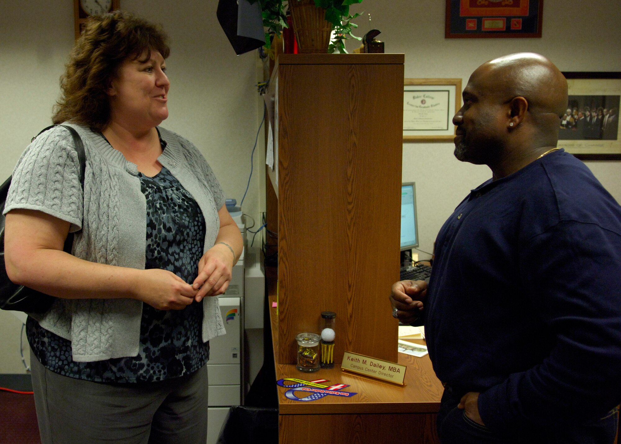 Karen Nixon, Air Force Network Integration Center, Knowledge Operations requirements lead, who is in the process of earning her Master’s of Business Administration degree from Park University, speaks to Keith Dailey from Park about a future class. Nixon is a recently retired Air Force veteran who has been using her benefits further her education and career. (U.S. Air Force photo by Senior Airman Amber R. Kelly-Herard) 