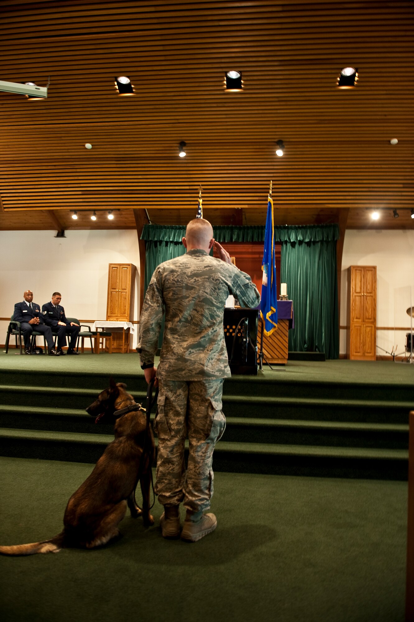 A military working dog handler and his dog pay respect to the memory of Rony, a deceased MWD, during a memorial ceremony at the base chapel on Hurlburt Field, Fla., March 16, 2012. Rony served on various patrol assignments, including security details for the president and vice president of the United States. (U.S. Air Force photo/Airman 1st Class Christopher Williams)(Released)