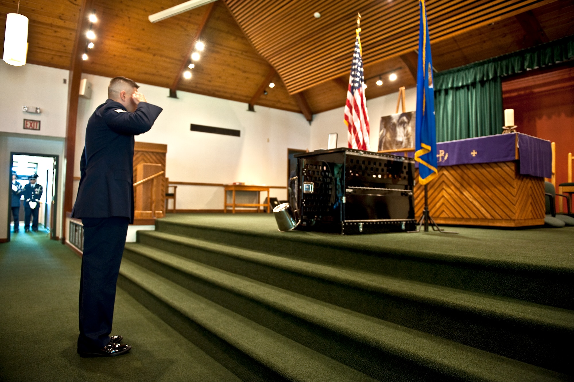 Staff Sgt. Robert Calhoun, a military working dog from the 1st Special Operations Security Forces Squadron, salutes a memorial display set up in honor of Rony, a deceased MWD, during a ceremony at the base chapel on Hurlburt Field, Fla., March 16, 2012. Calhoun and Rony worked together on deployments to Iraq and Afghanistan during a two-and-a-half year period. (U.S. Air Force photo/Airman 1st Class Christopher Williams)(Released)