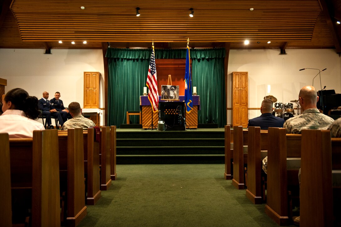 Airmen honor the life and legacy of Rony, a deceased military working dog from the 1st Special Operations Security Forces Squadron, during a memorial ceremony at the base chapel on Hurlburt Field, Fla., March 16, 2012. A “missing dog” display, consisting of an empty kennel, leash, and an inverted food bucket signifying the unbreakable bond between a handler and dog, centered in the chapel’s front stage. (U.S. Air Force photo/Airman 1st Class Christopher Williams)(Released)