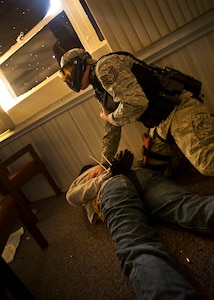 Tech. Sgt. Keith Lippy subdues a perpetrator during an active shooter scenario at Joint Base Charleston - Air Base March 20. During the active shooter scenario, the Anti-Terrorism/Force Protection exercise evaluated JB Charleston's capabilities in responding to a crisis situation. Sgt. Lippy is a 628th Security Forces Squadron patrolman. (U.S. Air Force photo by Airman 1st Class George Goslin)