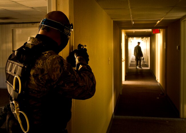Staff Sgt. Vincent Bustillo provides cover for another 628th Security Forces member at Joint Base Charleston - Air Base March 20.  During the active shooter scenario, the Anti-Terrorism/Force Protection exercise evaluated JB Charleston's capabilities in responding to a crisis situation. Sgt. Bustillo is a  628th Security Forces Squadron patrolman. (U.S. Air Force photo by Airman 1st Class George Goslin)