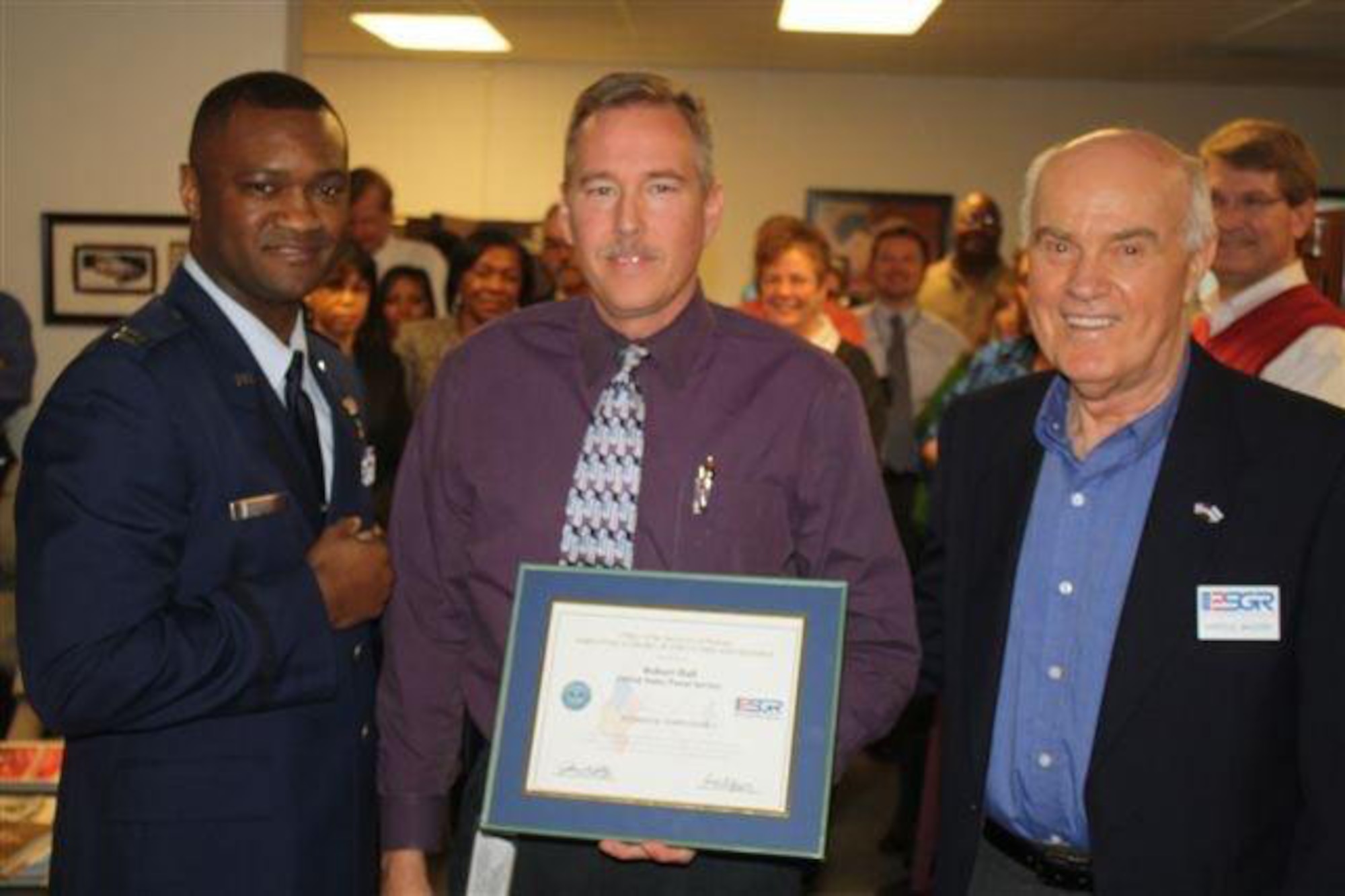 From left to right: Capt Jarius Wallace, 916th Maintenance Group, Mr. Robert Hall, United States Postal Service Greensboro District Area 3 director, and Lt. Col.(ret.) Harold Mcloud, ESGR liaison, pose for a photo after Wallace submitted his employer for an ESGR award. Currently more than 100 North Carolina employers are being considered for the 2012 Freedom Awards. (USAF courtesy photo)