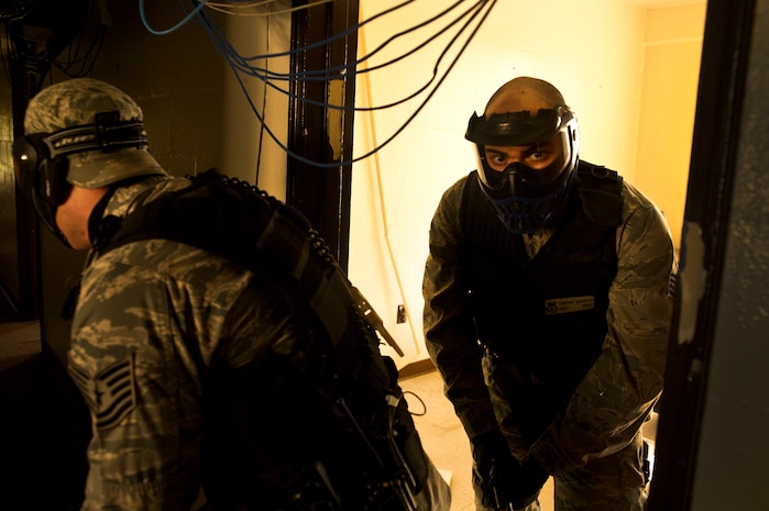Tech. Sgt. Keith Lippy and Staff Sgt. Vincent Bustillo clear rooms during an active shooter scenario at Joint Base Charleston - Air Base March 20. During the active shooter scenario, the Anti-Terrorism/Force Protection exercise evaluated JB Charleston's capabilities in responding to a crisis situation. (U.S. Air Force photo by Airman 1st Class George Goslin)