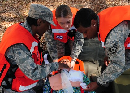 628th Medical Group personnel perform simulated life saving techniques on a volunteer  at Joint Base Charleston - Air Base March 20. During the active shooter scenario, the Anti-Terrorism/Force Protection exercise evaluated JB Charleston's capabilities in responding to a crisis situation. (U.S. Air Force photo/Staff Sgt. Katie Gieratz) 