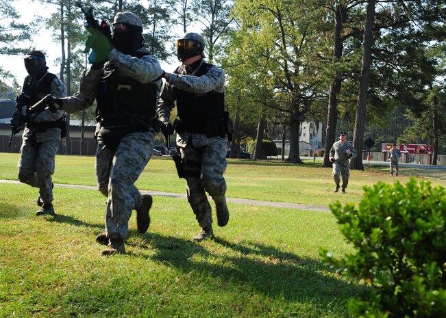 628th Security Forces Squadron members respond to a simulated terrorist attack at Joint Base Charleston - Air Base March 20. During the active shooter scenario, the Anti-Terrorism/Force Protection exercise evaluated JB Charleston's capabilities in responding to a crisis situation. (U.S. Air Force photo/Staff Sgt. Katie Gieratz) 