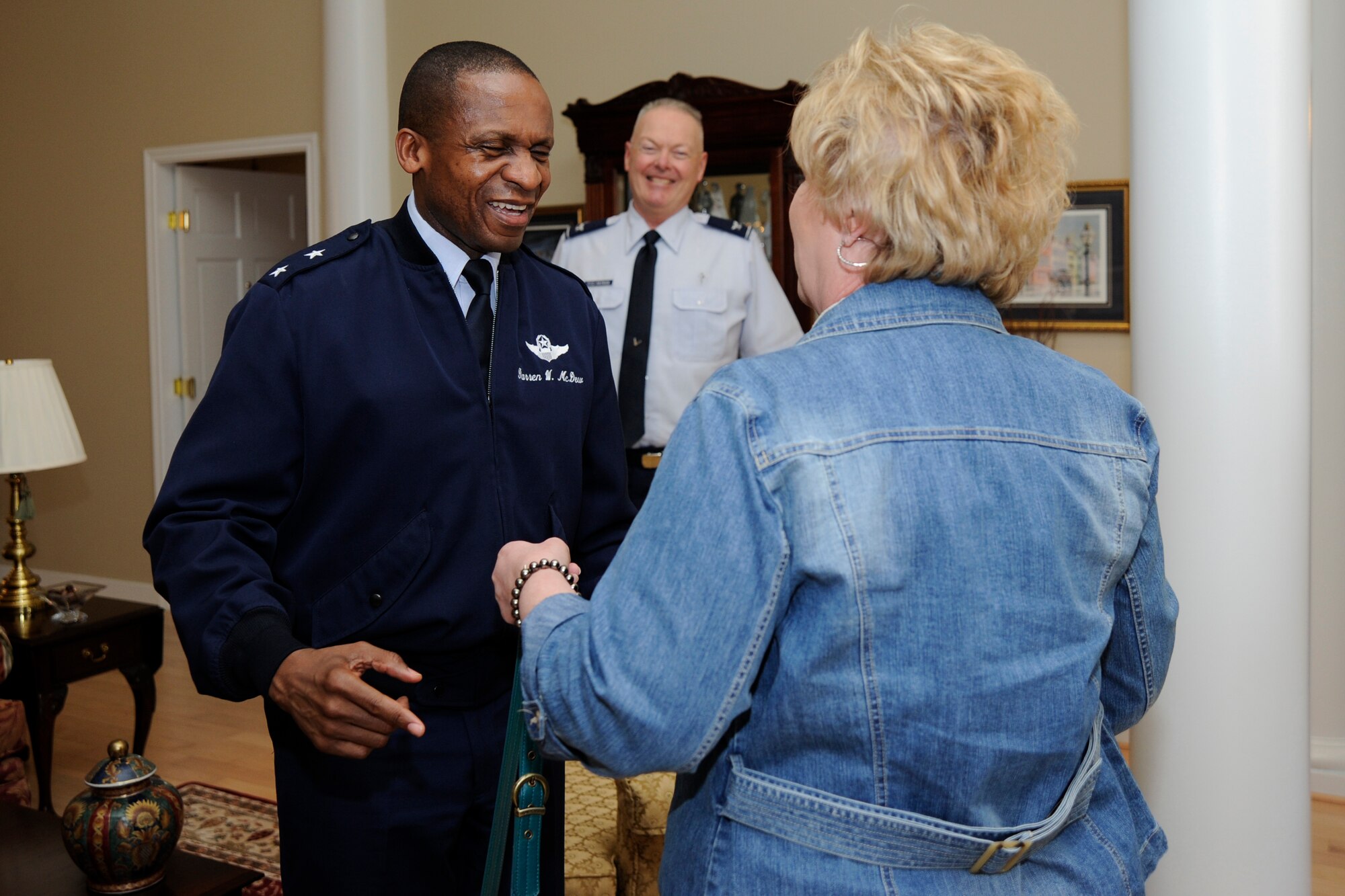 Air Force District of Washington Commander, Maj. Gen. Darren W. McDew greets Janet Grampp, Joint Base Andrews’ Fisher House manager, Mar. 15 on JBA, Md. The Fisher House program is a unique private-public partnership that supports America's military through a program that enables family members to be close to a loved one during hospitalization or treatment for illness, disease or injury. (U.S. Air Force photo by Staff Sgt. Christopher Ruano) 