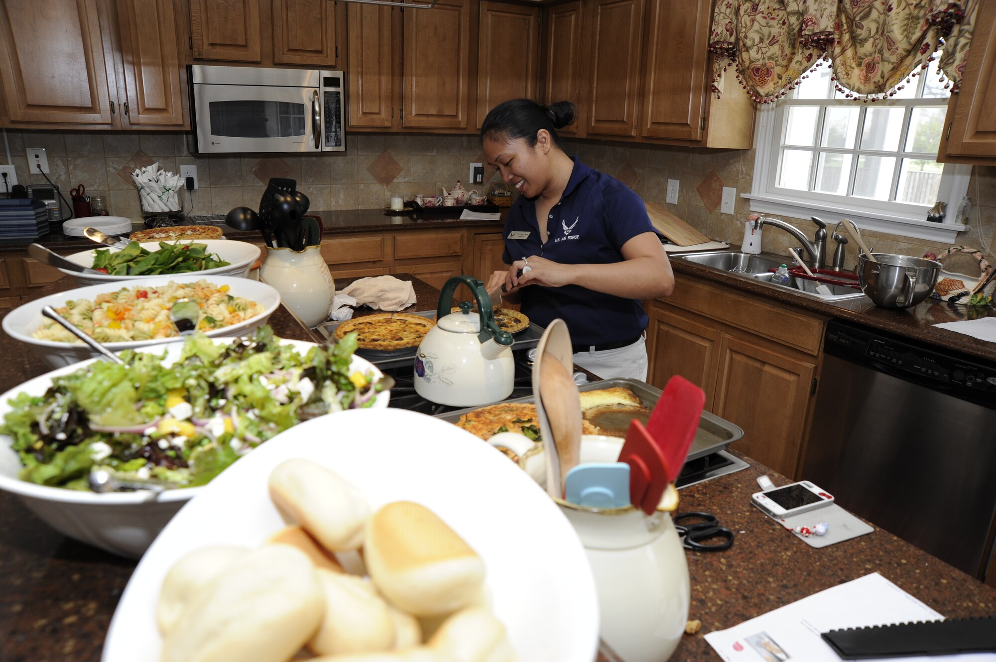 Tech. Sgt. Cheryl Rush, enlisted aide to Air Force District of Washington Commander, Maj. Gen. Darren W. McDew, prepares food for the Fisher House volunteers March 14 on Joint Base Andrews, Md. More than 13 volunteers came to the appreciation luncheon for the Fisher house held by the McDew family. (U.S. Air Force photo by Staff Sgt. Christopher Ruano)