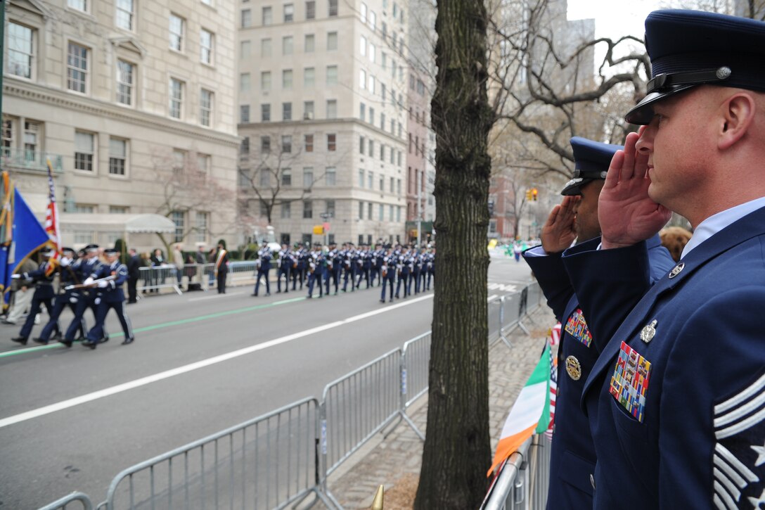 Air Force District of Washington Commander Maj. Gen. Darren W. McDew and Command Chief Master Sgt. Scott A. Fuller salute the U.S. Flag carried by the U.S. Air Force Honor Guard March 17 during the 251st annual St. Patrick’s Day Parade in New York City, N.Y. (U.S. Air Force photo by Tech. Sgt. Raymond Mills) 