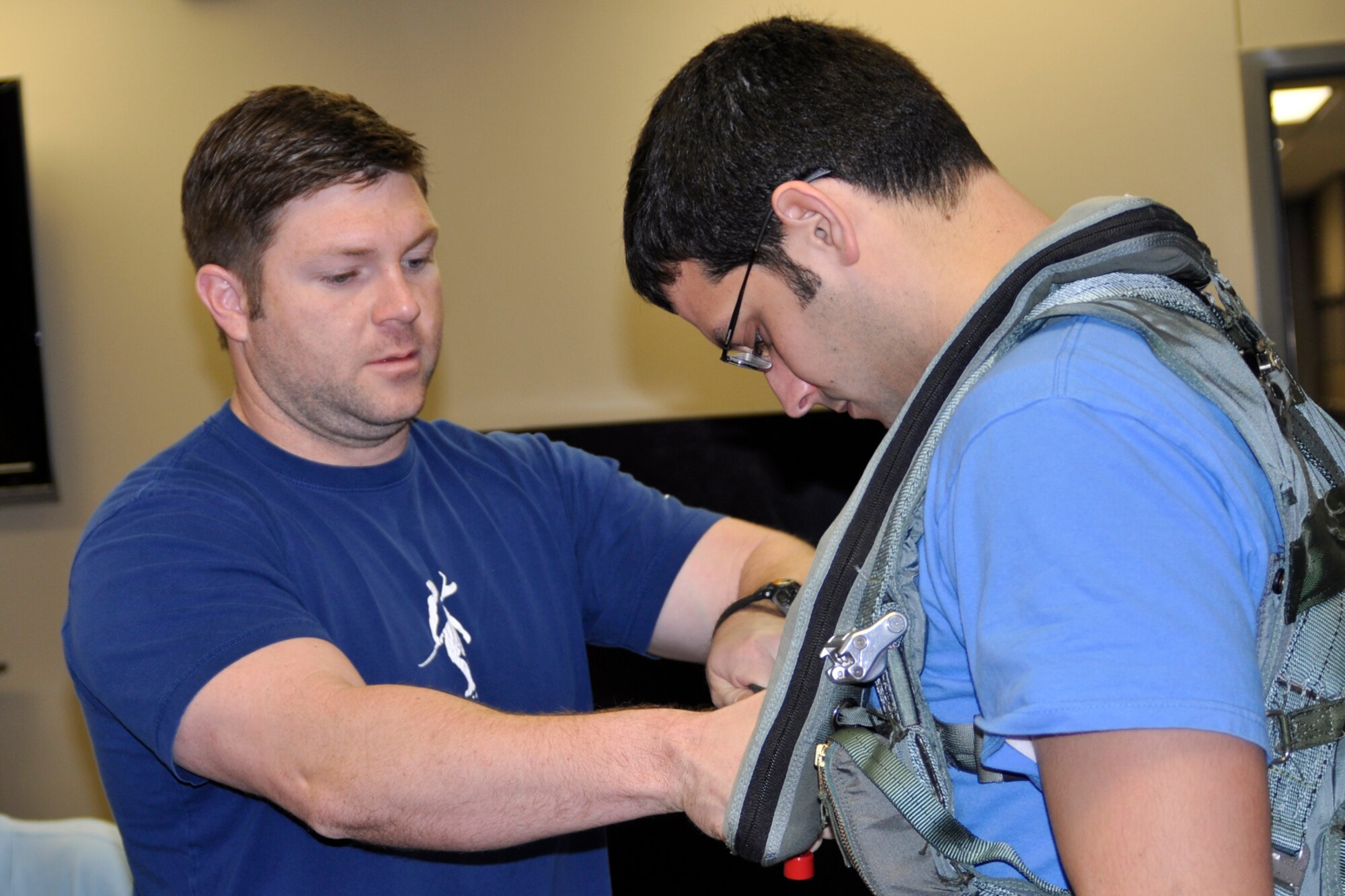 Patrick Smith, an aircrew flight equipment technician assigned to the 917th Operations Support Flight, straps Anthony Armaly, a U.S. Air Force Civilian Career Trainee from Wright Patterson Air Force Base, Ohio, into a parachute harness at Barksdale Air Force Base, La., March 15, 2012. Armaly is part of the Palace Acquire program, which is the Air Force’s civilian career development program that encompasses 2-3 years of entry level training which includes both: on-the-job training and formal training courses. (U.S. Air force photo by Betty Stephens/Released)