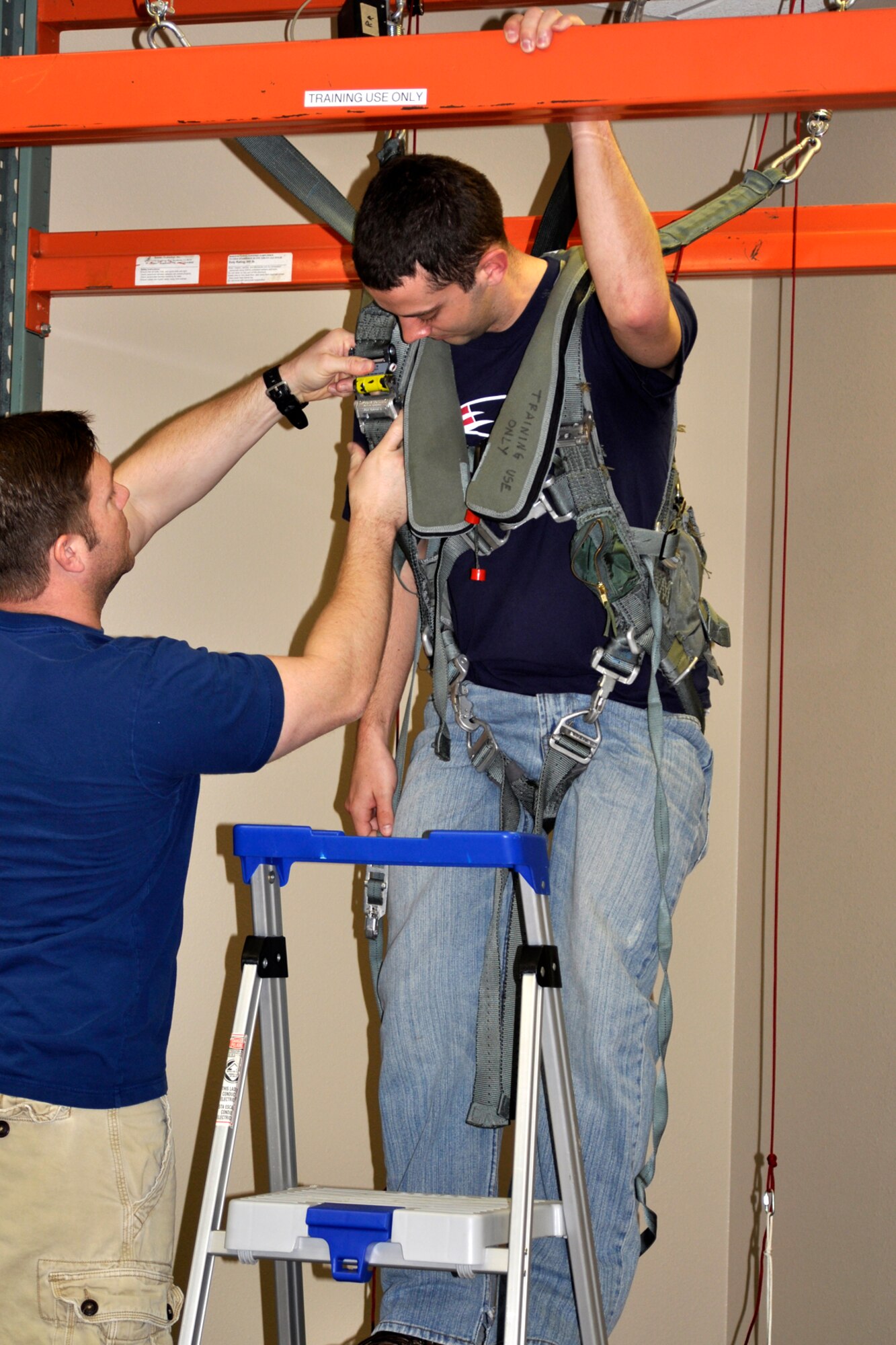 Patrick Smith, an aircrew flight equipment technician assigned to the 917th Operations Support Flight, straps Ian Oxender, a U.S. Air Force Civilian Career Trainee from Wright Patterson Air Force Base, Ohio, into a parachute simulator at Barksdale Air Force Base, La., March 15, 2012. Oxender is part of the Palace Acquire program, which is the Air Force’s civilian career development program that encompasses 2-3 years of entry level training which includes both: on-the-job training and formal training courses. (U.S. Air force photo by Betty Stephens/Released)