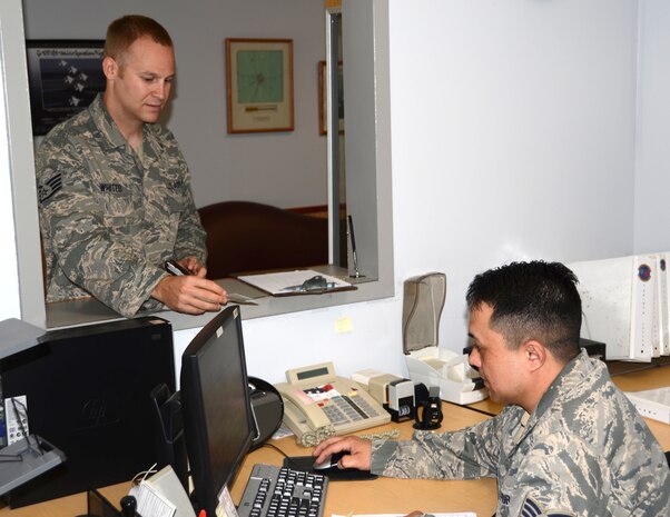 Tech. Sgt. Robert Johnson, 628th Logistics Readiness Squadron Vehicle Operations non-commissioned officer in charge of records and licensing, assists Staff Sgt. Kenneth Whited from the 628th LRS, with obtaining a government drivers license March 14 at Joint Base Charleston – Air Base. To operate a government vehicle on base, drivers must possess a government driver’s license. Drivers need a military identification card, a valid state driver’s license and an Air Force Form 171 filled out by their unit vehicle control officer to obtain the government drivers license. (U.S. Air Force photo by Senior Airman Anthony J. Hyatt)