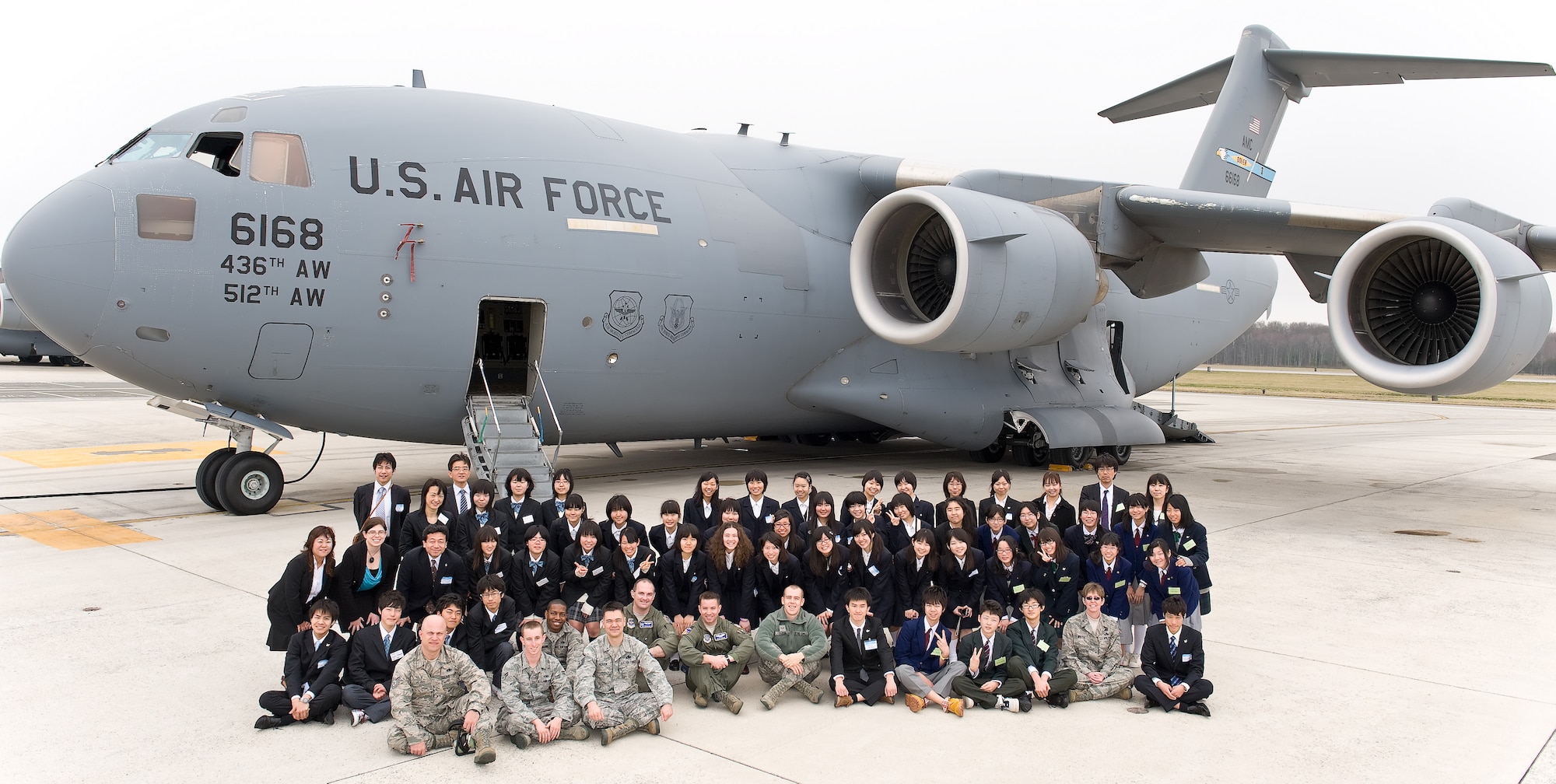 Members of the Japanese delegation from Miyagi Prefecture, Japan, and service members from Dover Air Force Base, Del., pose in front of a C-17 Globemaster III March 20, 2012, during a tour of Dover AFB. The tour marked the 15th anniversary of the visits between Miyagi Prefecture and its sister city of Dover, Del.  (U.S. Air Force photo by Roland Balik)