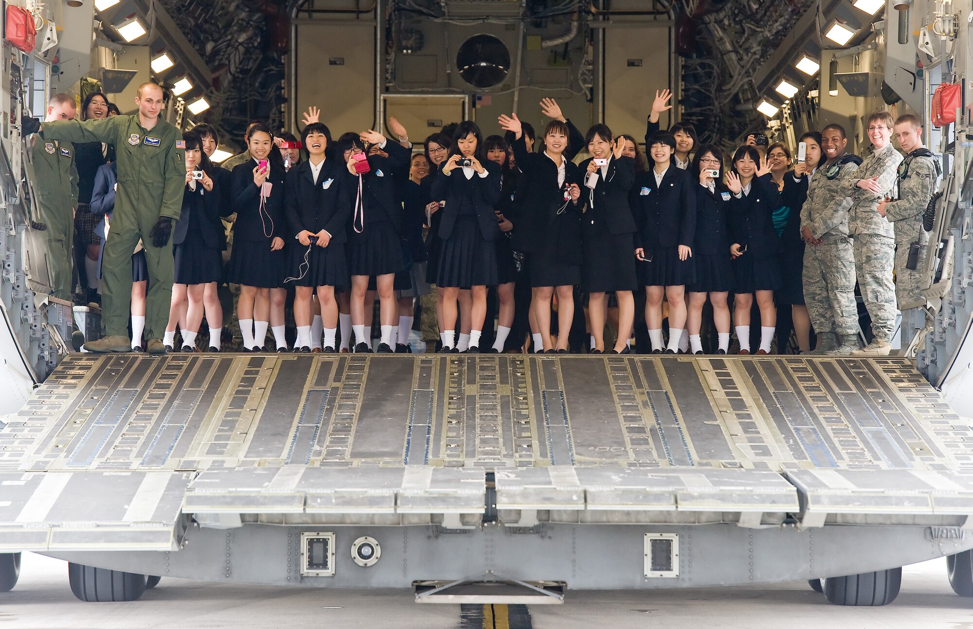 Members of the Japanese delegation from Miyagi Prefecture, Japan, pose on the aft loading ramp of a C-17 Globemaster III March 20, 2012, during a tour of Dover Air Force Base, Del. The tour marked the 15th anniversary of the visits between Miyagi Prefecture and its sister city of Dover, Del.  (U.S. Air Force photo by Roland Balik)