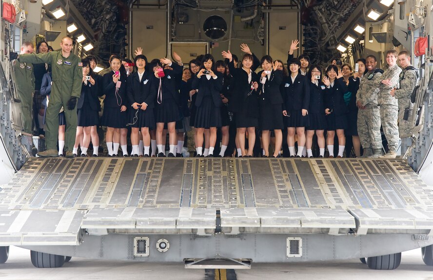 Members of the Japanese delegation from Miyagi Prefecture, Japan, pose on the aft loading ramp of a C-17 Globemaster III March 20, 2012, during a tour of Dover Air Force Base, Del. The tour marked the 15th anniversary of the visits between Miyagi Prefecture and its sister city of Dover, Del.  (U.S. Air Force photo by Roland Balik)