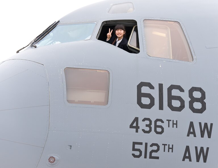 A member of the Japanese delegation from Miyagi Prefecture, Japan, smiles out the window of a C-17 Globemaster III on March 20, 2012, during a tour of Dover Air Force Base, Del. The tour marked the 15th anniversary of the visits between Miyagi Prefecture and its sister city of Dover, Del. (U.S. Air Force photo/Roland Balik)