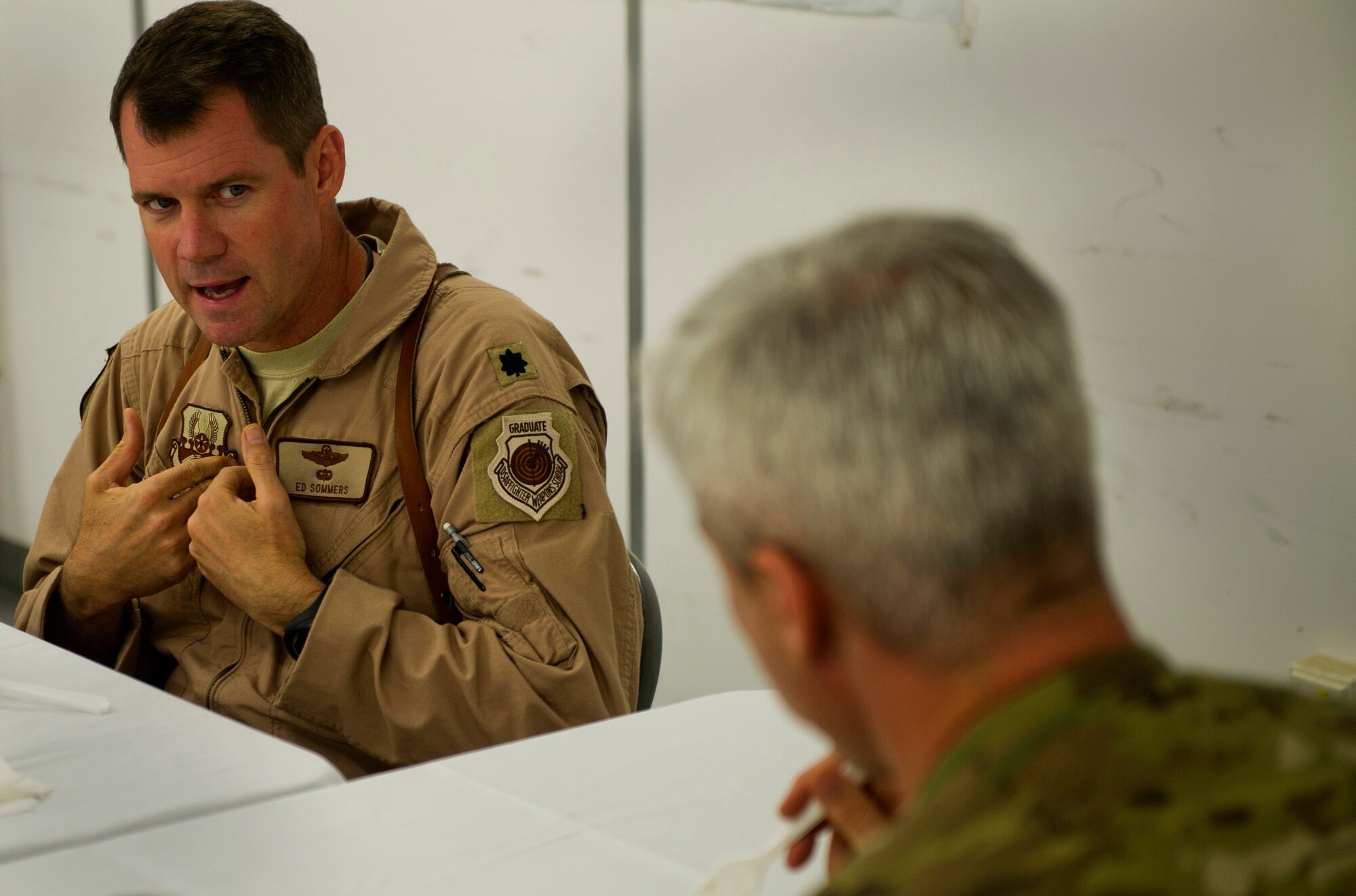 Lt. Col. Ed Sommers, 651st Air Expeditionary Group deputy commander, explains issues he's facing to Chief Master Sgt. Robert Sealey, U.S. Air Forces Central command chief at Camp Bastion, Afghanistan, March 16, 2012. During this dinner meeting, Sommers explained how his group often faces challenges being located away from an U.S. air base. The very next day, Sealey was able to get the base commandant to agree for an Air Force representative to be on the Camp's board. (U.S. Air Force photo by Staff Sgt. David Salanitri) 

