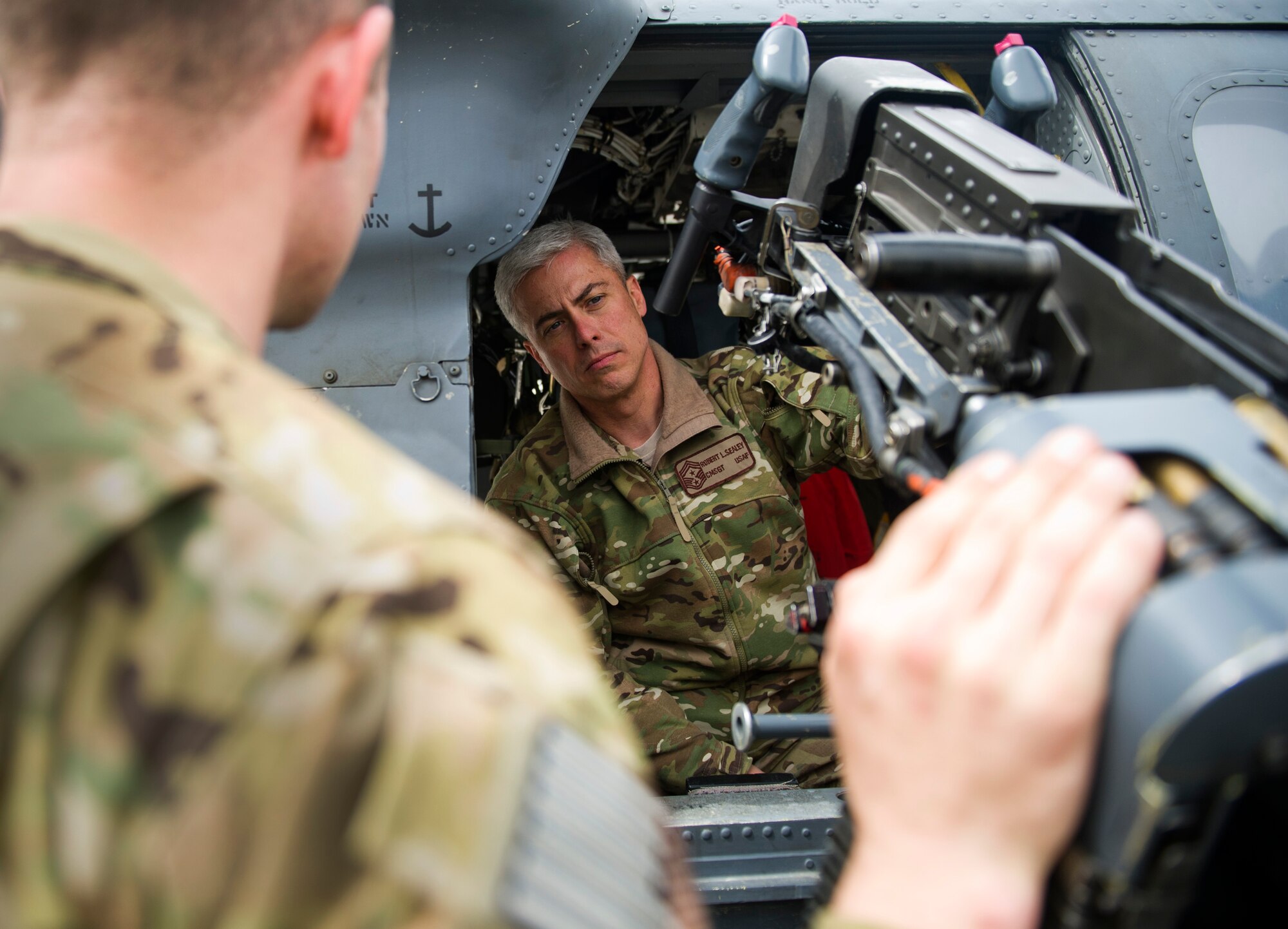 The gunner's duty and equipment on a HH-60 Blackhawk is explained to Chief Master Sgt. Robert Sealey, U.S. Air Forces Central command chief, March 14, 2012 at Bagram Airfield, Afghanistan. This helicopter is used for combat search and rescue missions here. (U.S. Air Force photo by Staff Sgt. David Salanitri) 


