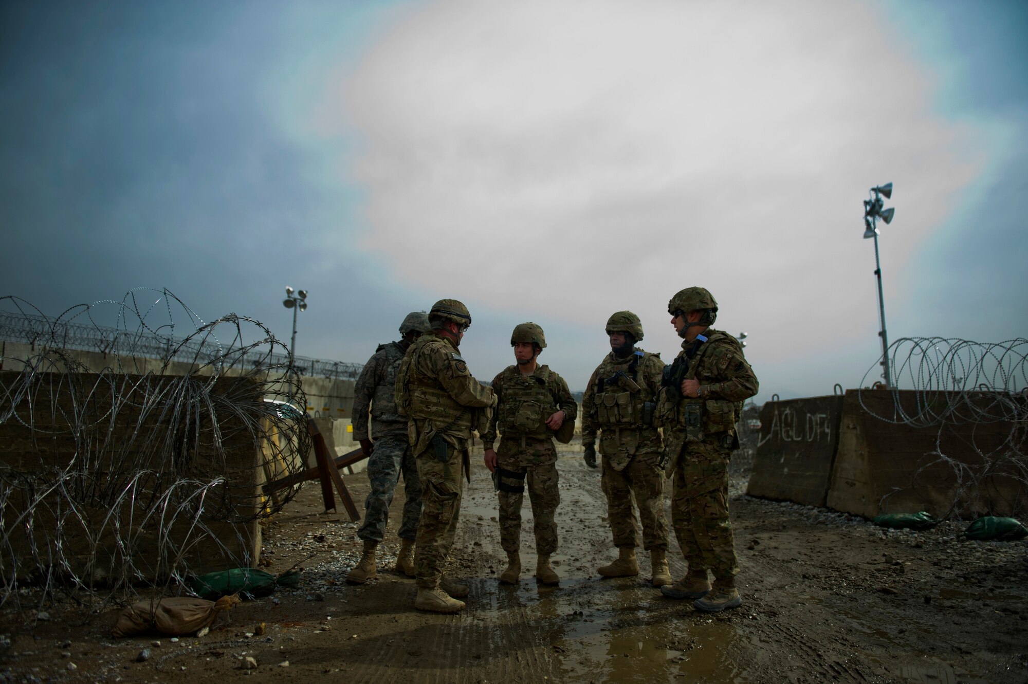 Center, Chief Master Sgt. Robert Sealey, U.S. Air Forces Central command chief, is briefed about entry control points, March 14, 2012 at Bagram Airfield, Afghanistan. Only weeks earlier, 2,500 Afghan protesters tried to force their way through this ECP, but were denied entry by dedicated 455th Expeditionary Security Forces Squadron Airmen. Sealey is a former security forces Airman. (U.S. Air Force photo by Staff Sgt. David Salanitri)