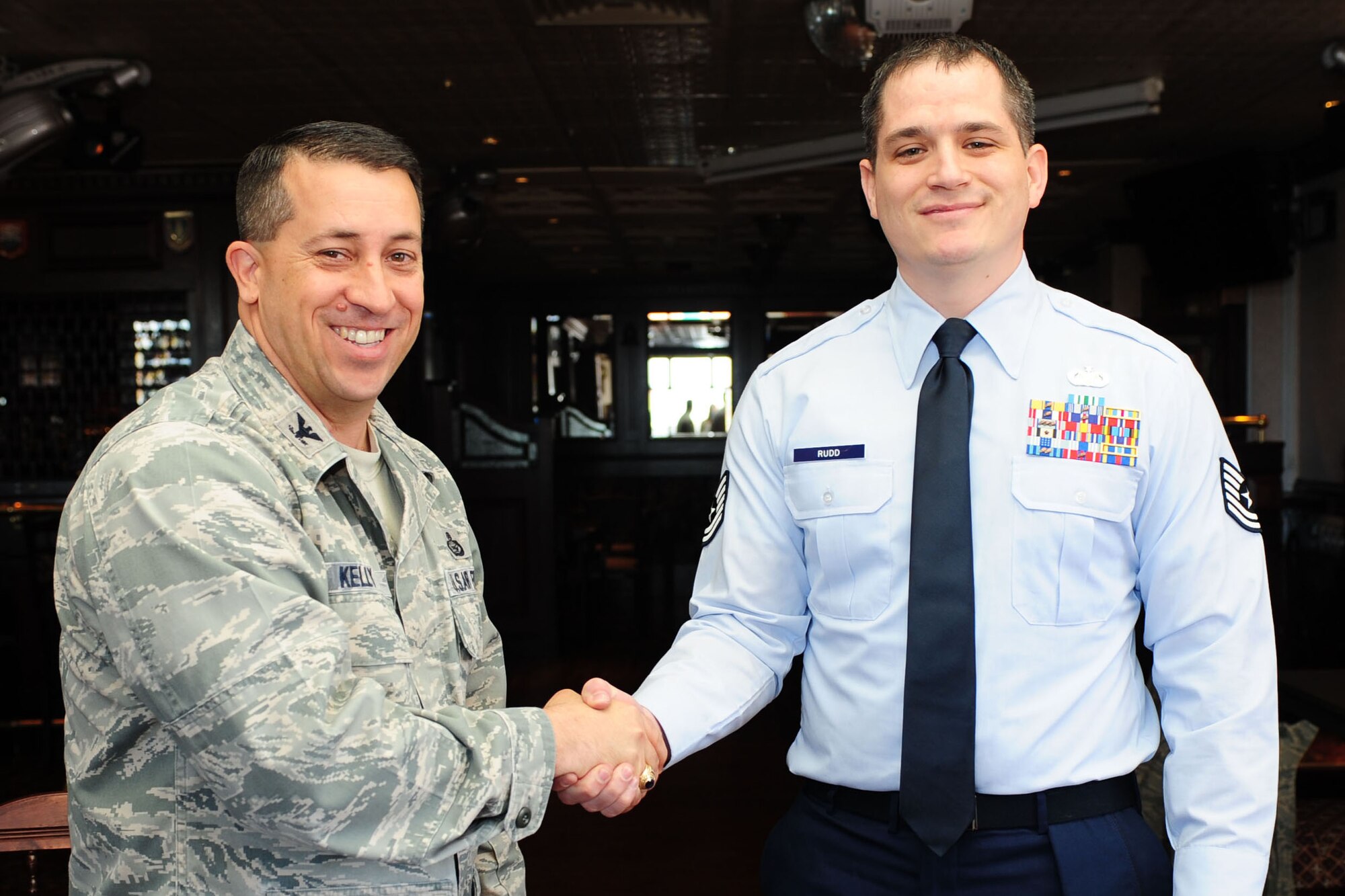 RAF MENWITH HILL, United Kingdom - Col. Brian Kelly, 501st Combat Support Wing commander, presents the Innovator of the Month Award to Tech. Sgt. William Rudd, 421st Air Base Group. Rudd developed an all-volunteer tax program, after the group did not have funding this year to hire a person to run the tax center. (U.S. Air Force photo by Staff Sgt. Ave Young)