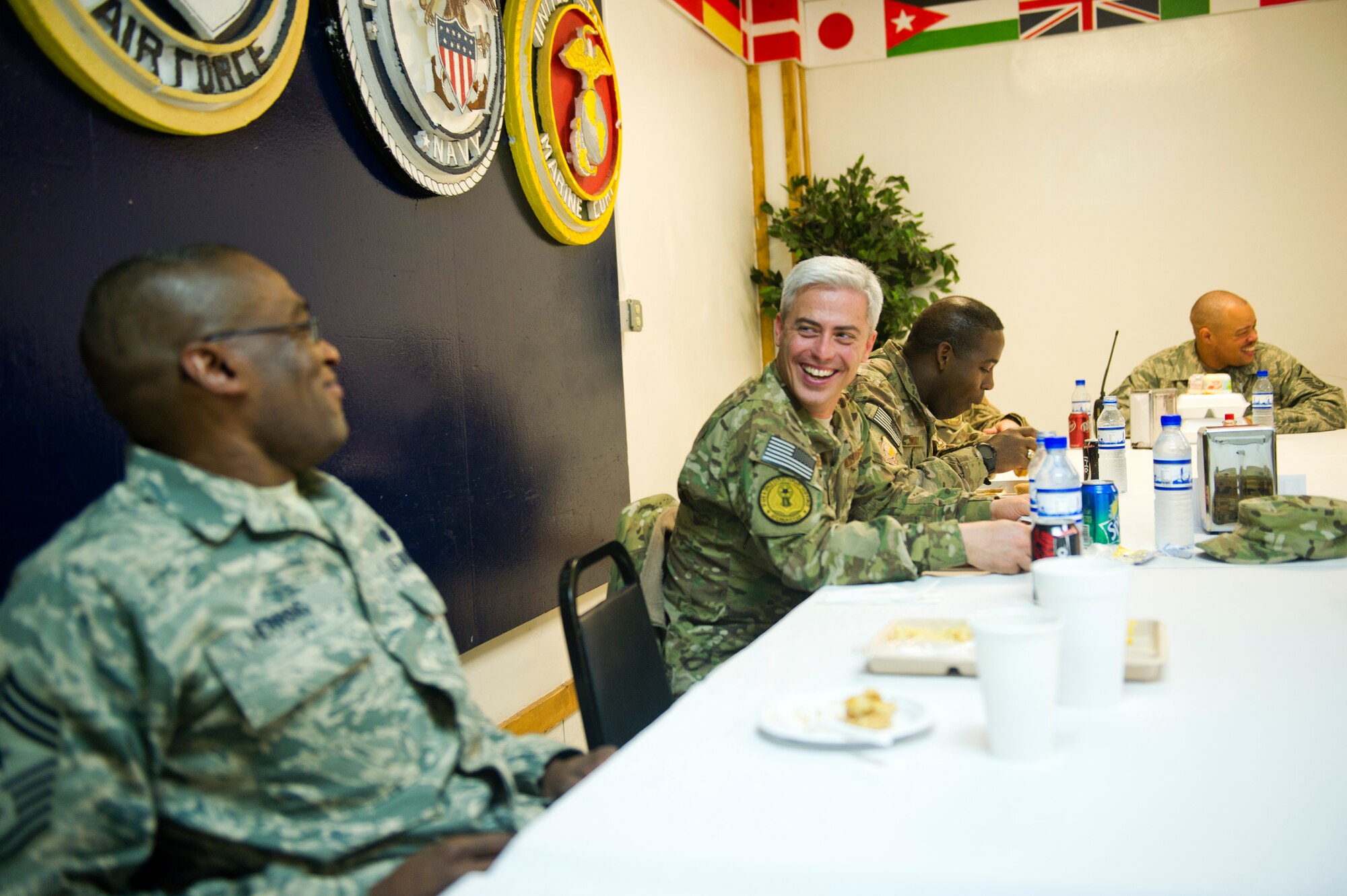 Middle, Chief Master Sgt. Robert Sealey, U.S. Air Forces Central command chief, laughs at a joke made by Chief Master Sgt. Al Herring, 9th Air and Space Expeditionary Task Force - Afghanistan command chief, during a dinner with first sergeants and chiefs March 13, 2012 at Bagram Airfield, Afghanistan. During this trip, Herring doesn't have to try hard to get his peers and Airmen to laugh. (U.S. Air Force photo by Staff Sgt. David Salanitri)  